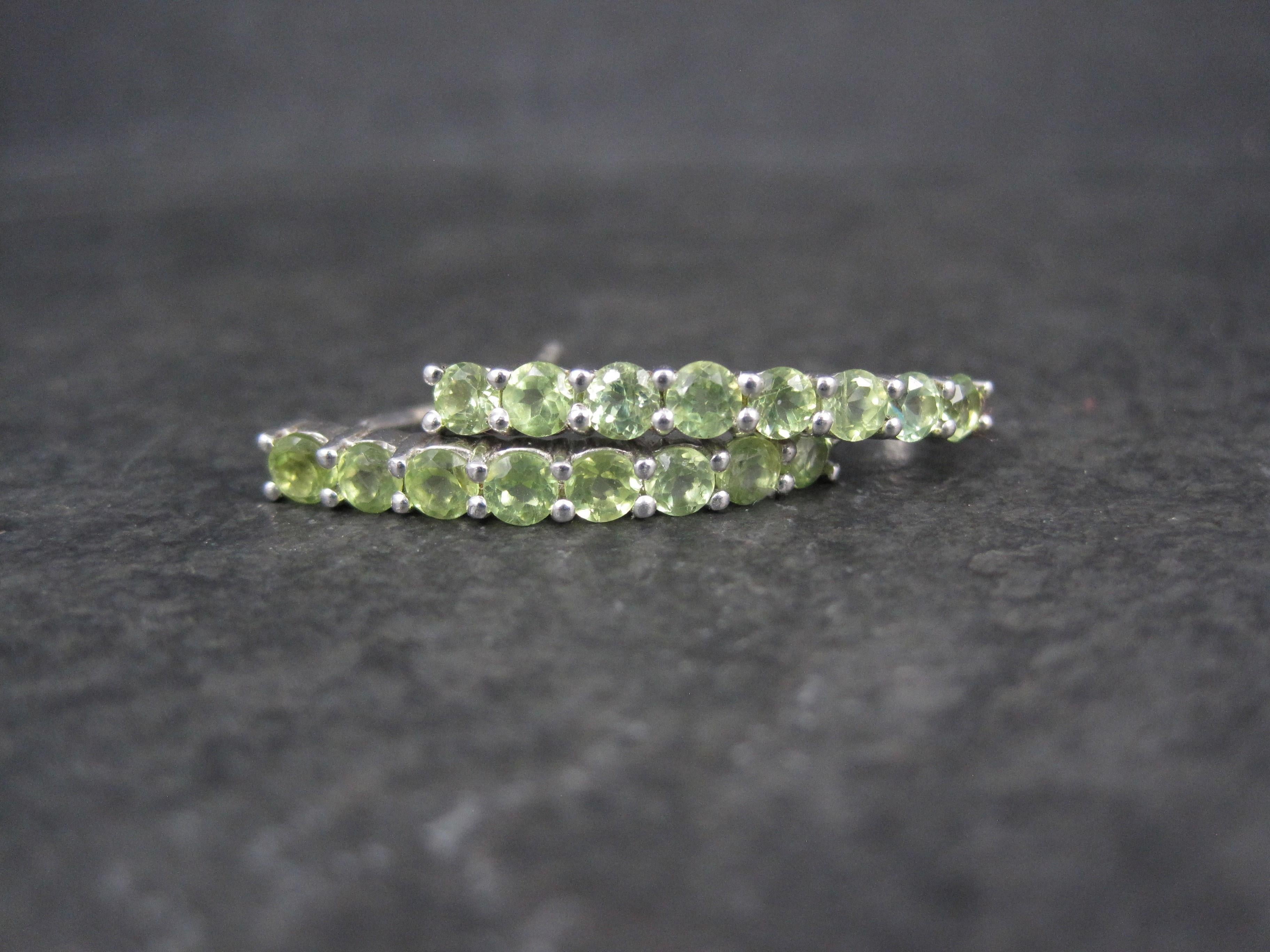 These beautiful earrings are sterling silver.
The pair features 16 round cut, 3mm peridot gemstones.
Measurements: 1/8 by 1 inch
Weight: 3.3 grams
Condition: New old stock