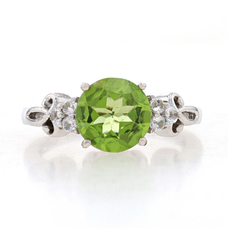 Size: 8 1/4
Sizing Fee: Up 2 sizes for $30

Metal Content: Sterling Silver

Stone Information
Natural Peridot
Cut: Round
Color: Green

Natural White Topaz
Cut: Round

Style: Solitaire with Accents

Measurements
Face Height (north to south): 3/8