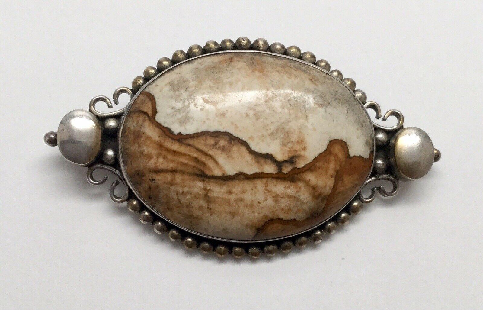 Sterling Silver Picture / Landscape jasper petrified wood pendant pin.

Marked 925

Measures: 2 1/2