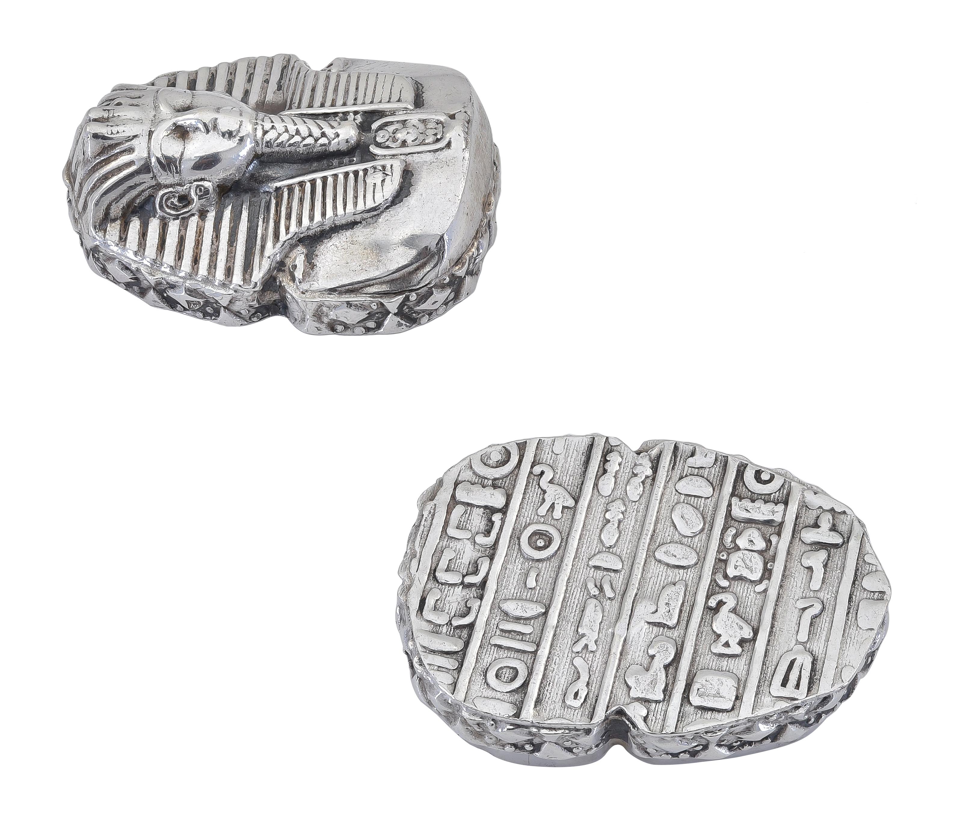 Small sterling silver covered box.  The top has a three-dimensional depiction of a Pharaoh.  The sides and bottom have various embossed talismans. 1 1/2