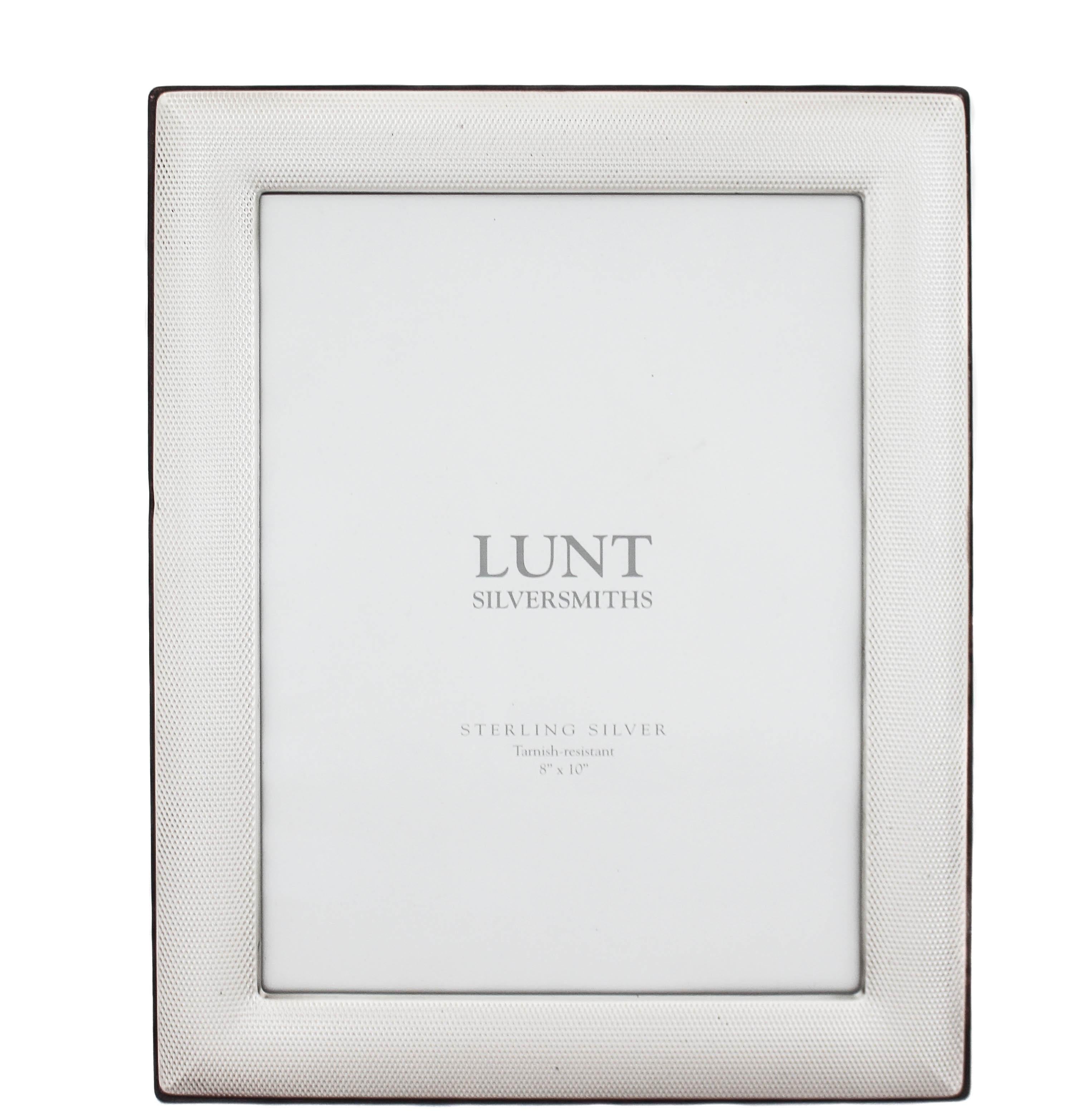 We are offering a new sterling silver picture frame by Lunt Silversmiths. Manufactured in Italy, it is tarnish resistant and has a wood back. The sterling silver front has a python pattern (texture) that is universal and works in any decor.