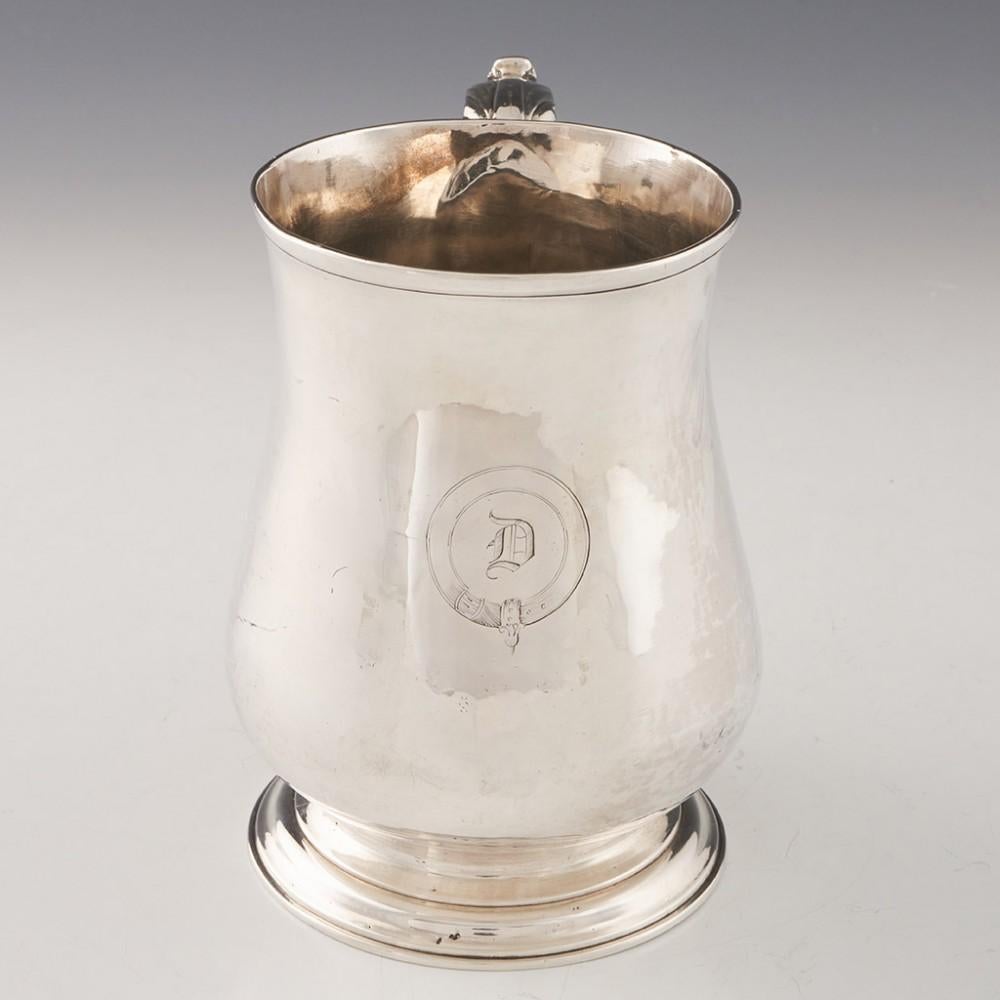 Heading : Georgian silver pint tankard
Date : Hallmarked in London in 1764, makers mark sadly rubbed
Period : George III
Origin : London, England
Decoration : Baluster form with an acanthus leaf thumb piece on a scrolled hanlde. Circular cartouche