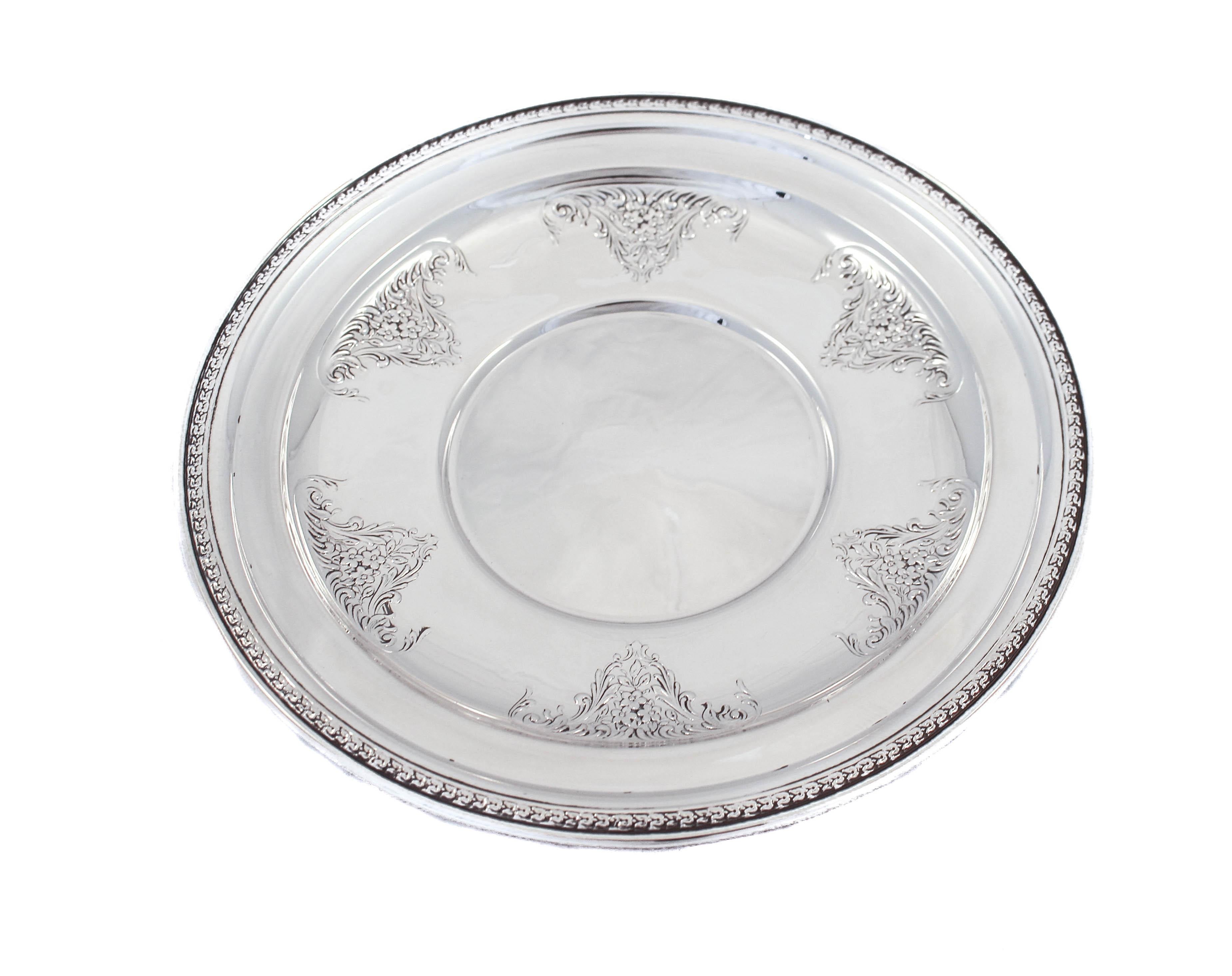 Being offered is a sterling silver dish made by the Manchester Manufacturing Company of Providence, Rhode Island. It’s an elegant piece with six bouquets of flowers encircling the inside edge. Around the outer rim there is a very subtle gadroon