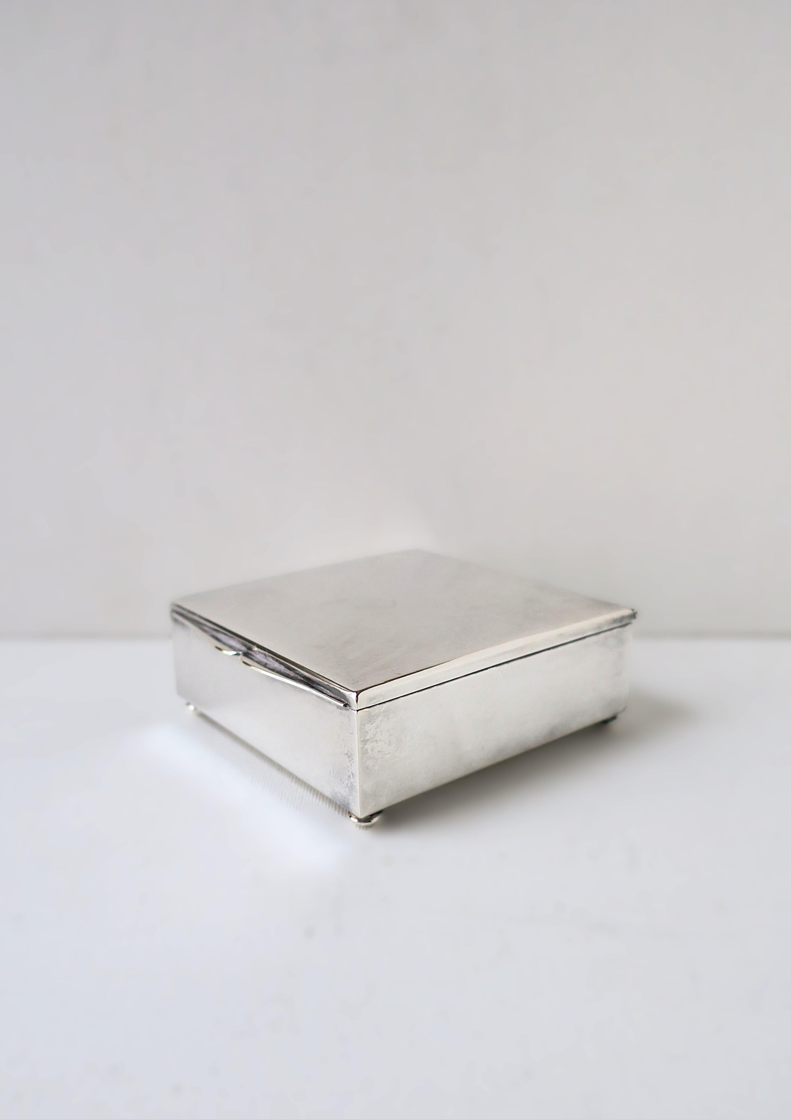 A sterling silver-plate German box with teak wood interior, circa early to mid-20th century, Germany. I'm showing piece as a jewelry box (holding earrings); however, it's actually a cigarette, tobacco, etc., box. A great box to hold small items on a