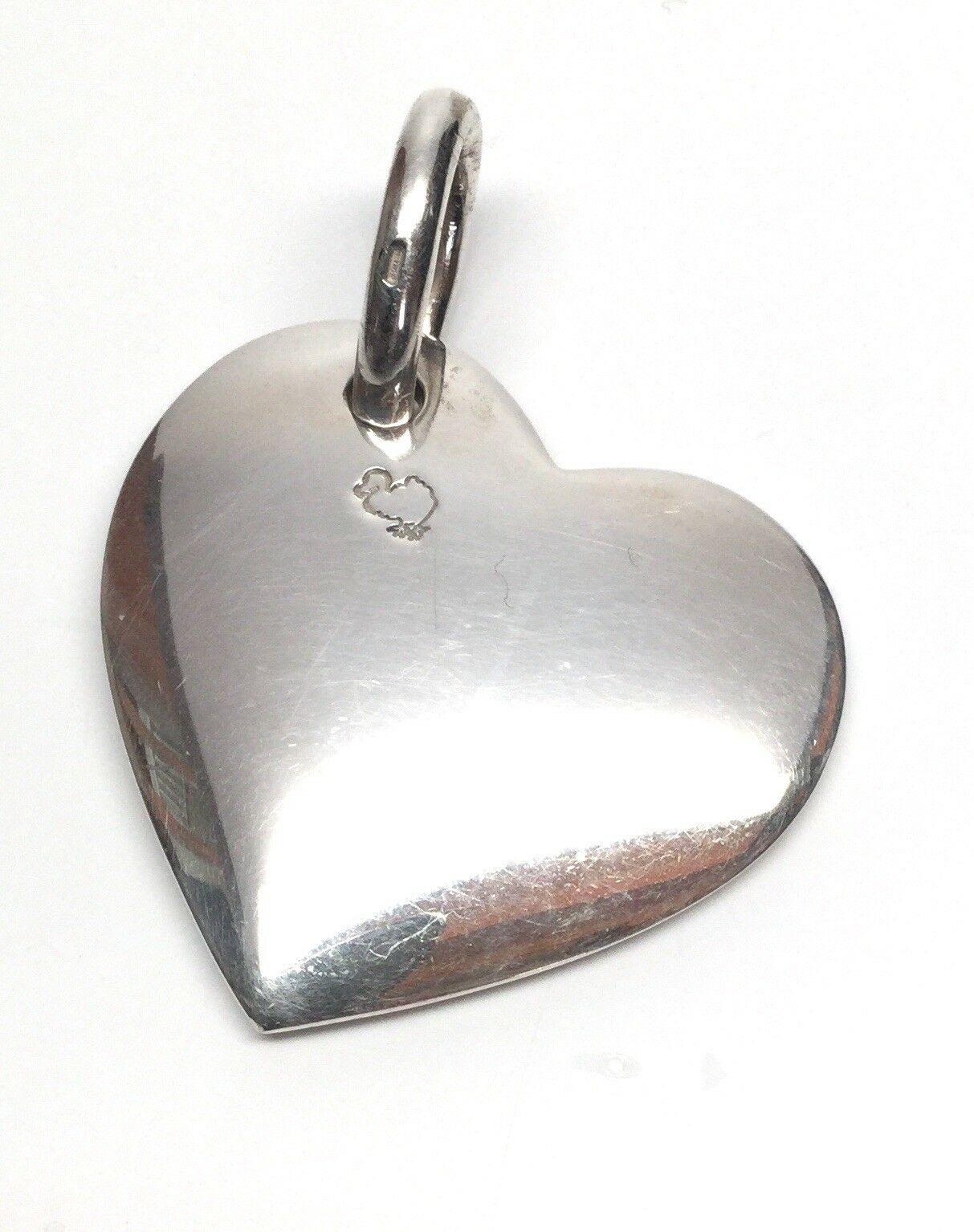 Sterling Silver Pomellato Dodo Heavy Sterling Silver Heart Pendant Necklace
This is a big solid chunky heavy sterling silver heart. It's quite beautiful as it dangles at an angle.  The back of the heart is hallmarked with a dodo bird. This is the