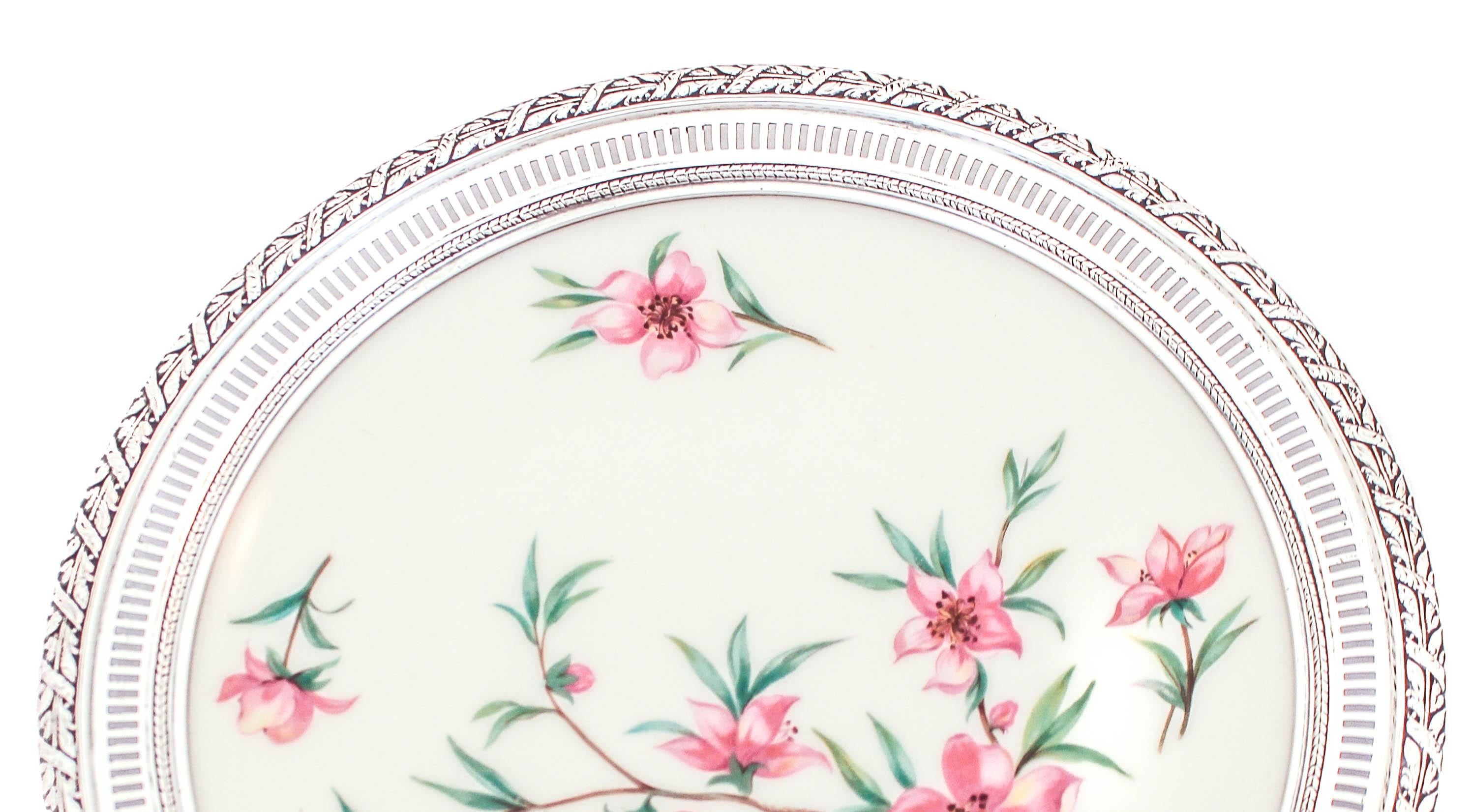 Being offered is a sterling silver and porcelain plate.  The boarder is sterling and made by Fisher Brothers and the plate is porcelain and made by Lenox China.  The silver has a cutout pattern and floral design going around the rim.  The porcelain