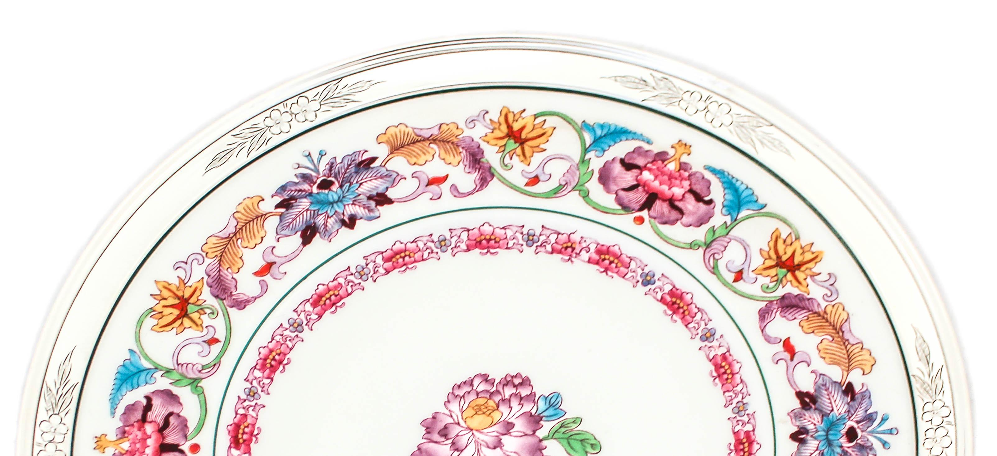This sterling silver and porcelain platter is made by the world famous Wedgwood Company of England. Hand painted with vibrant colors; turquoise, mustard, plum, green, and different shades of red. Incased in a sterling silver rim etched with flowers