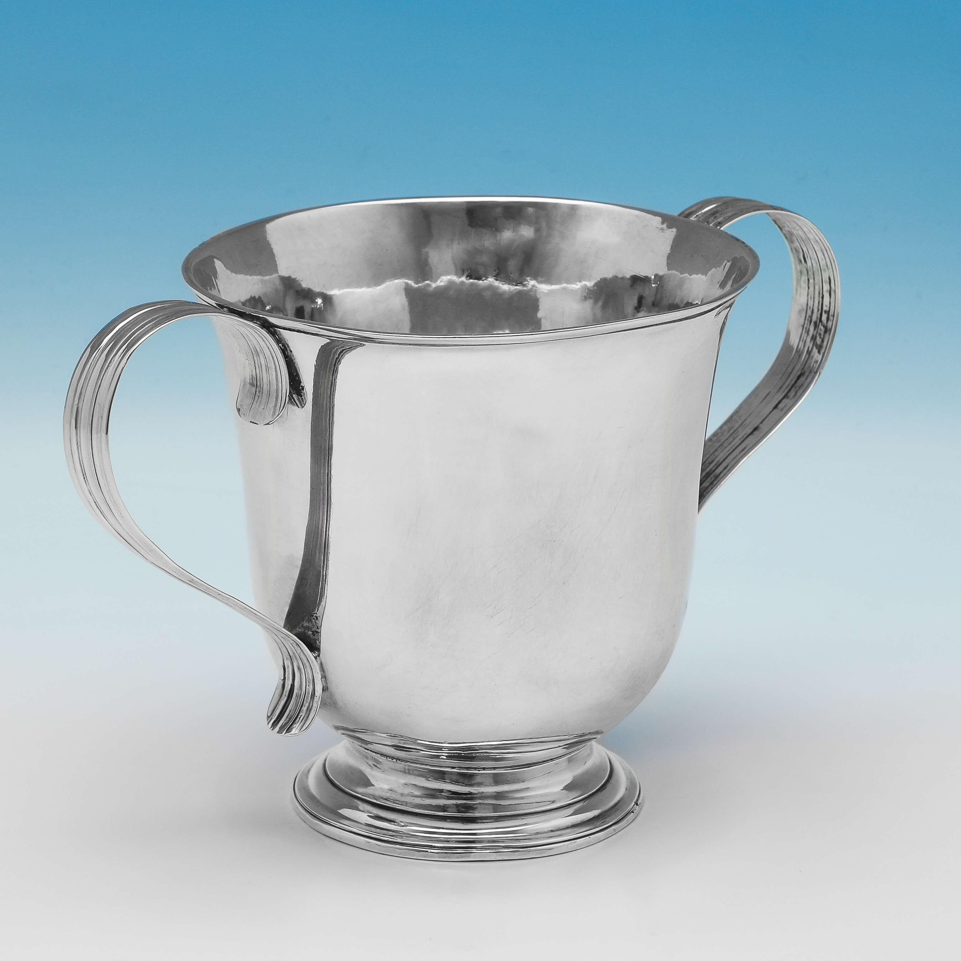 Hallmarked in London in 1780 by Hester Bateman, this very handsome, George III, antique sterling silver porringer, is plain in style, featuring reed bordered loop handles, and reed detailing around the foot and rim. The porringer measures