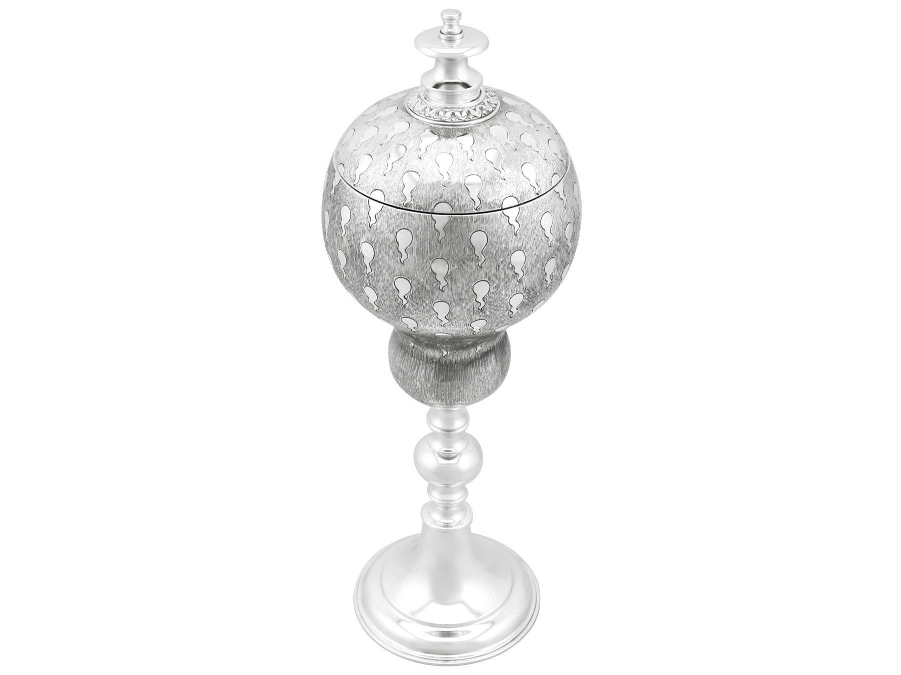 An exceptional, fine and impressive vintage Elizabeth II English sterling silver cup and cover; an addition to our presentation silverware collection.

This exceptional vintage Elizabeth II sterling silver cup and cover has a rounded gourd shaped