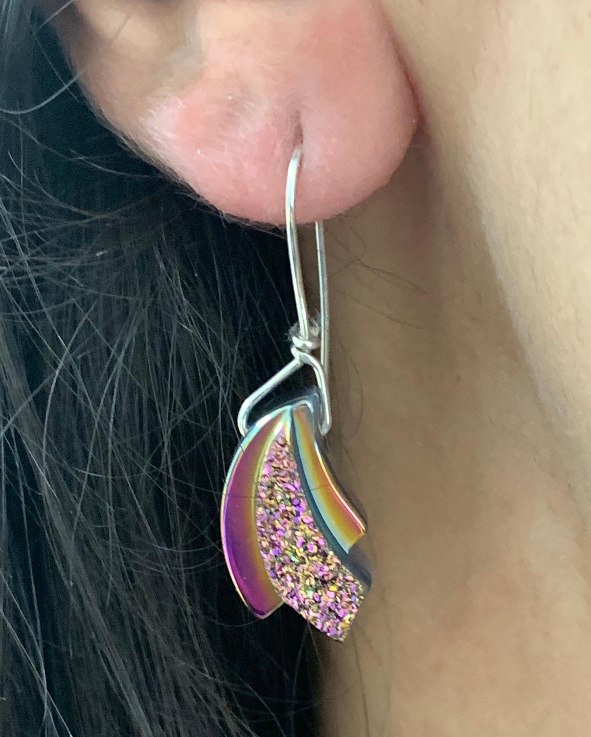 A stunning piece, these Druzy stones are a perfect match in quality and color. These earrings will have all eyes on you!

Material: Sterling Silver
Center Stone Details: Two Rainbow Titanium Druzys