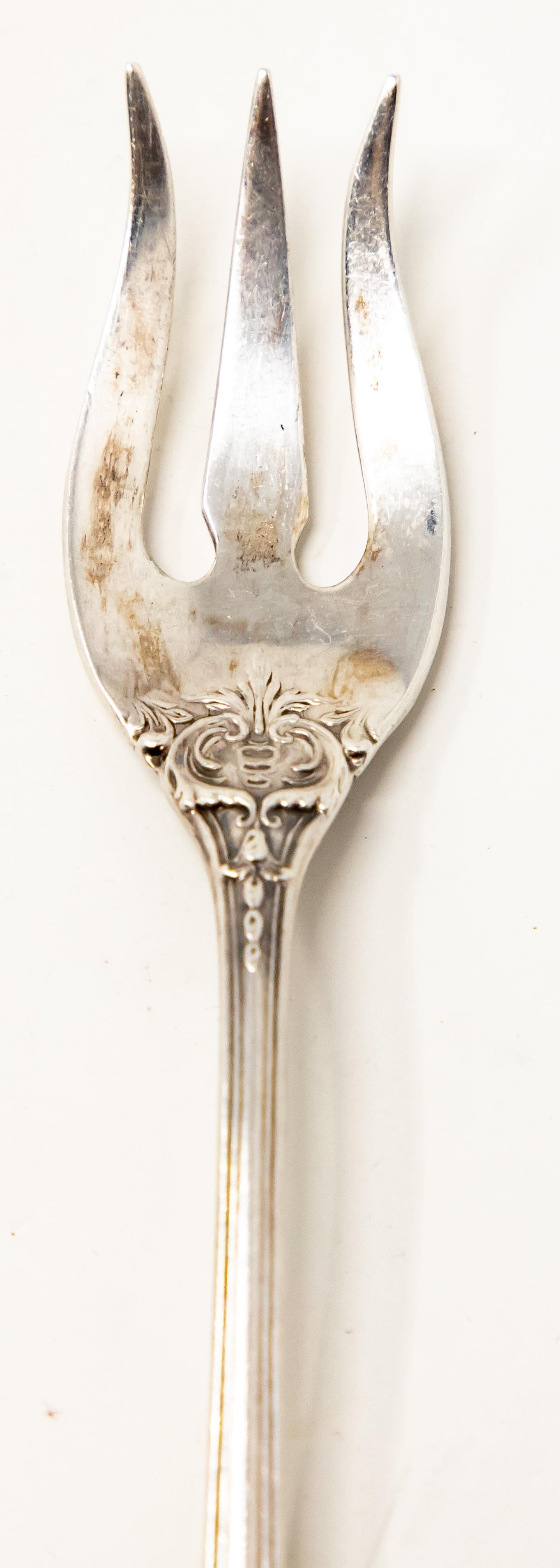 Offering this Francis, Reed and Barton cocktail fork. Having scrollwork and foliate designs. The back of the handle is marked REED & BARTON, STERLING.