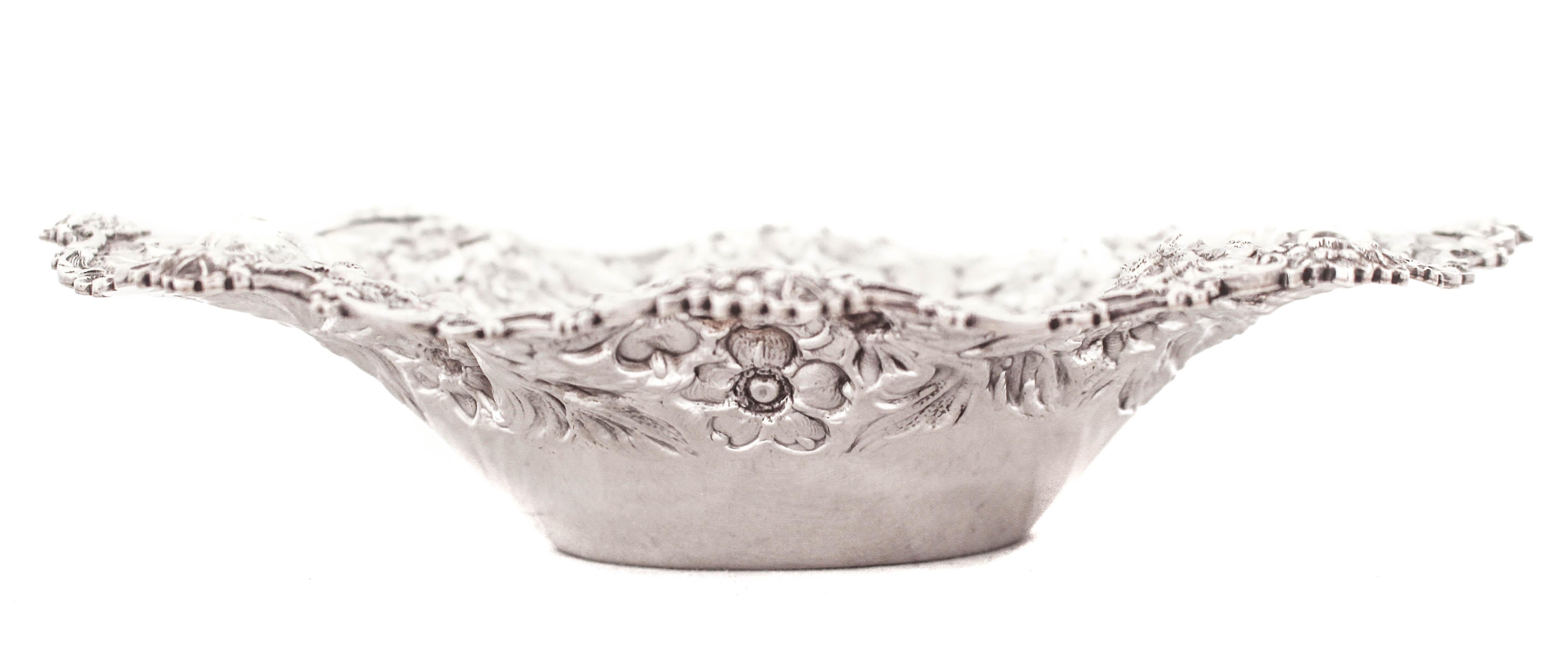 Being offered is a sterling silver bowl by S. Kirk & Sons of Baltimore, Maryland.  Famous for their iconic “Repousse” pattern; a rich and ornate floral motif.  The bowl rim is not only scalloped but fluted too.  All along the edge an assortment of