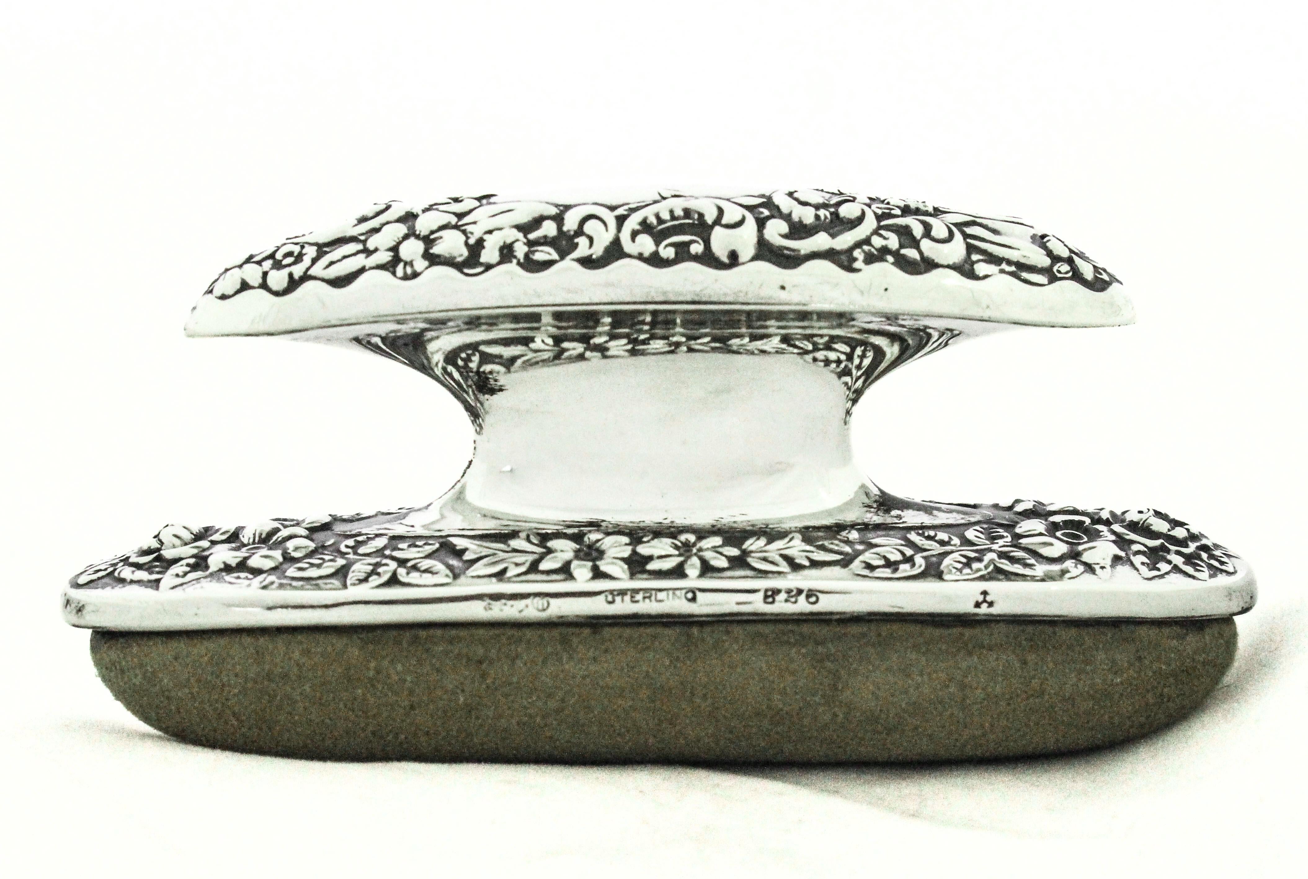 A beautifully crafted sterling silver nail buffer by Gorham Silversmiths, dated 1898, exemplifying the opulent design sensibility of America’s Gilded Age. The piece features a domed, hand-chased repoussé surface, richly decorated with scrolling