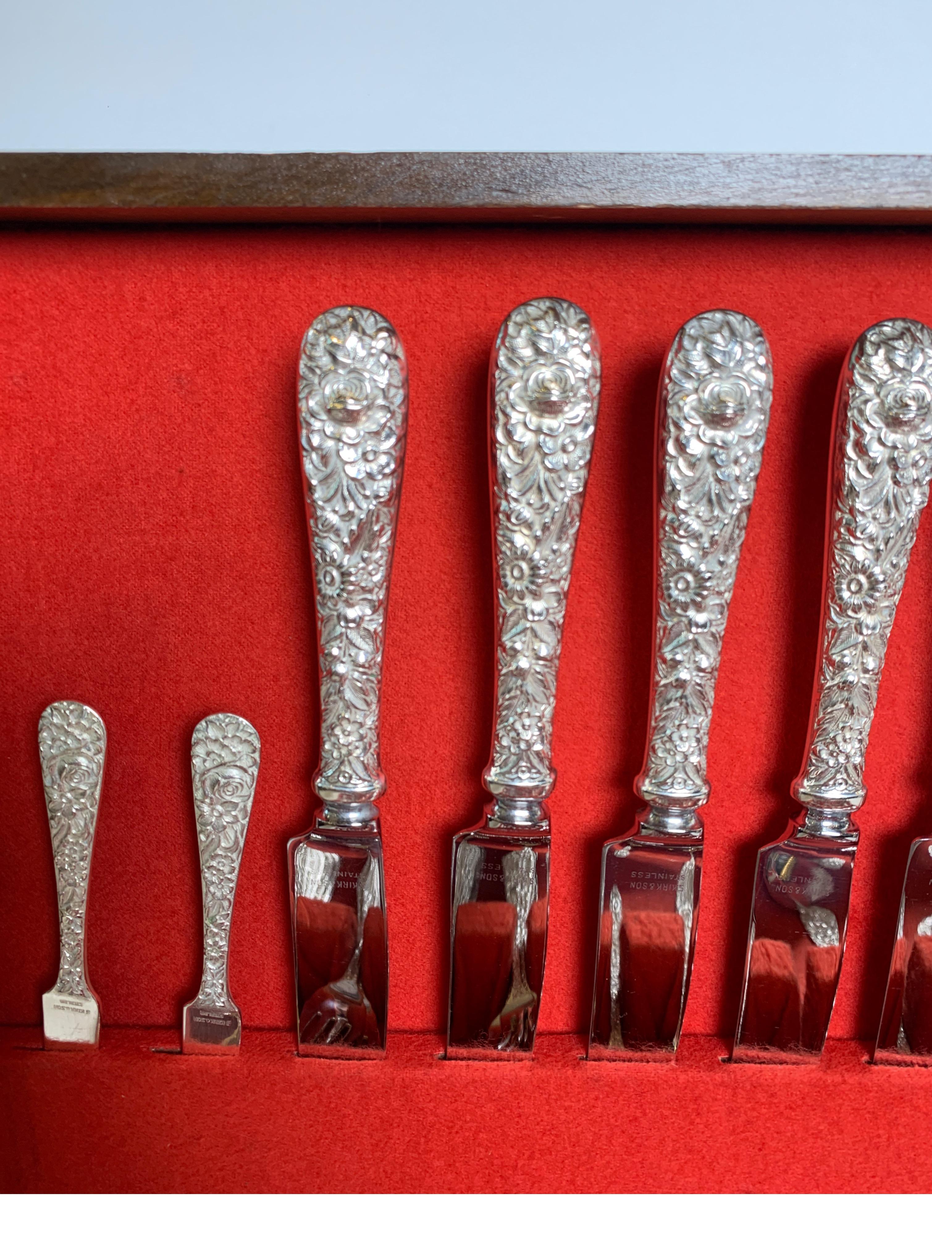 A set of Kirk & Son sterling flatware. Classic repousse consisting of 8 knives, 8 dinner forks, 8 salad forks, 8 iced tea spoons, 8 coctail forks, 11 teaspoons, 6 serving spoons, 2 butter knives, 1 meat fork, 1 carving fork, 1 carving knife, 2 berry