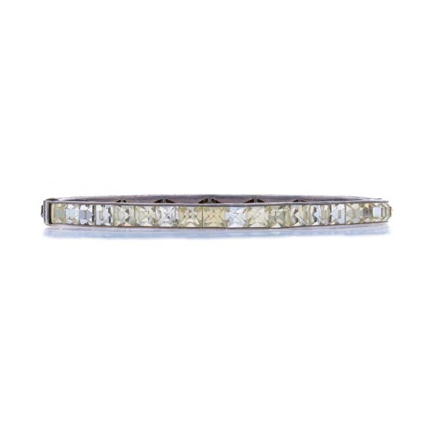 Era: Art Deco
Date: 1920s - 1930s

Metal Content: Sterling Silver

Stone Information

Rhinestones

Style: Bangle
Fastening Type: Tab Clasp with Hook Safety Clasp
Theme: Floral
Features: Etched & Milgrain Detailing

Measurements

Inner Circumference: