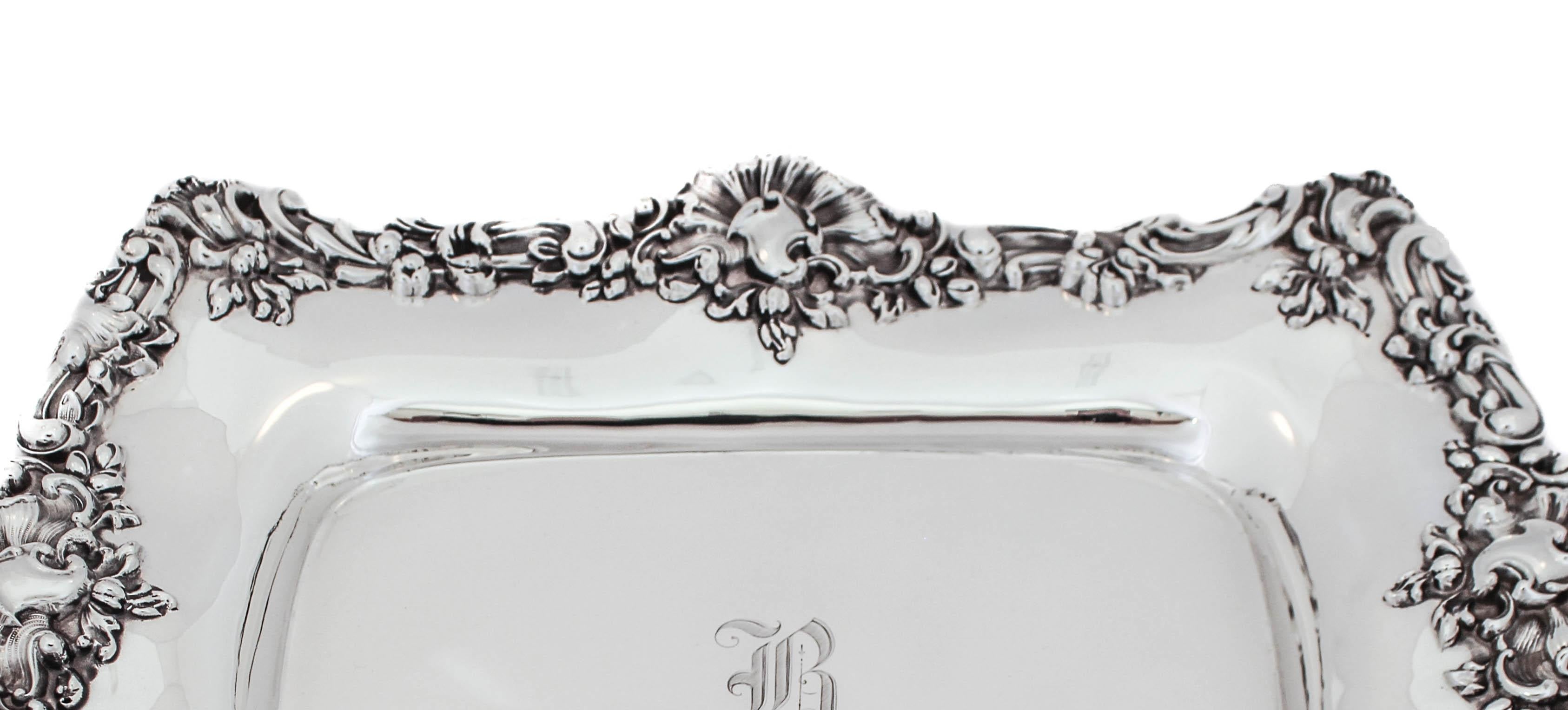 Being offered is sterling silver oblong platter by William Durgin Silver.  An exceptional example of Rocco style, this antique piece has a rich and elaborate design along the fluted edge. Silver pieces designed in the Rocco style featured natural