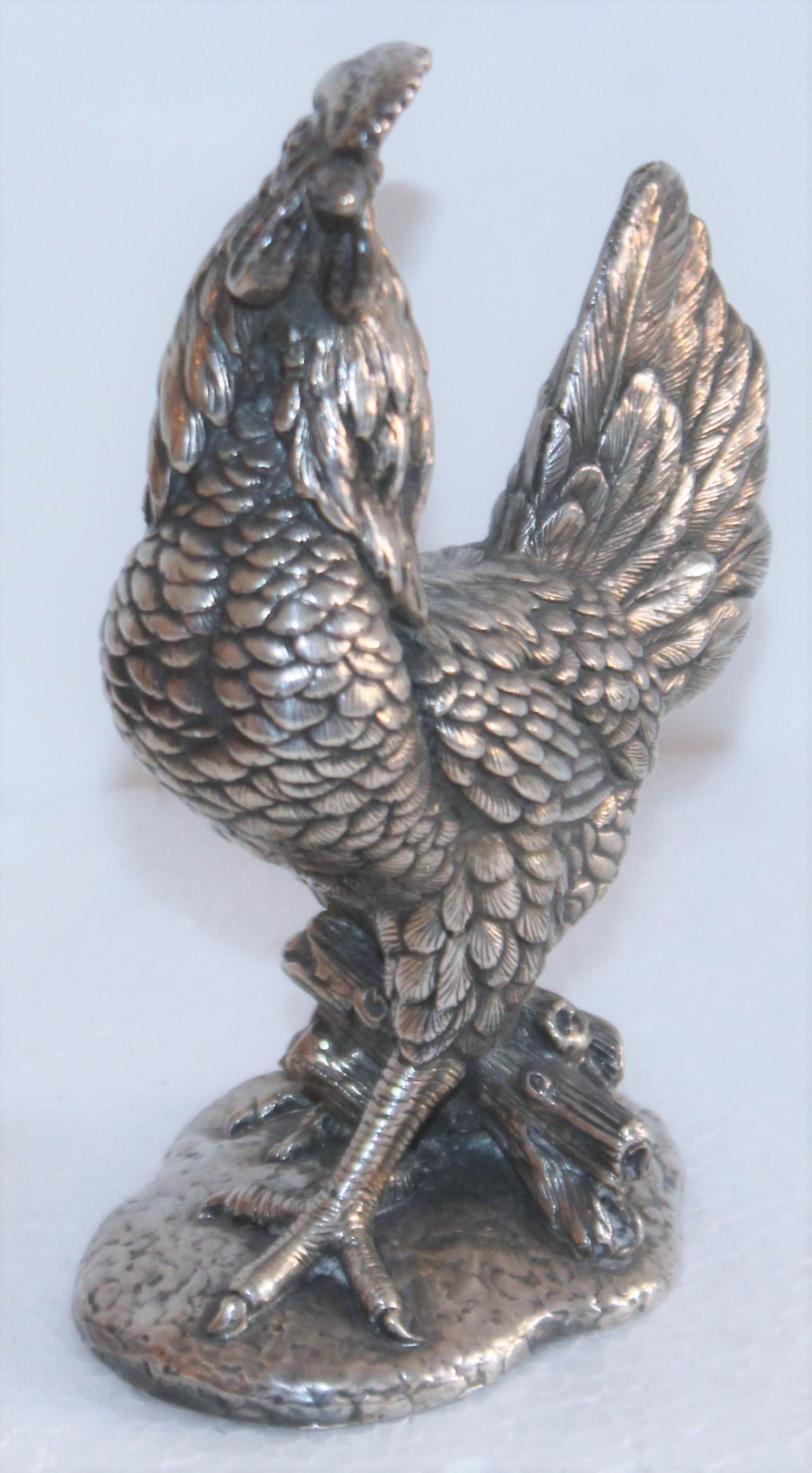 This sterling silver heavy hollow body rooster figure is signed 925 on the base and is in fine condition.