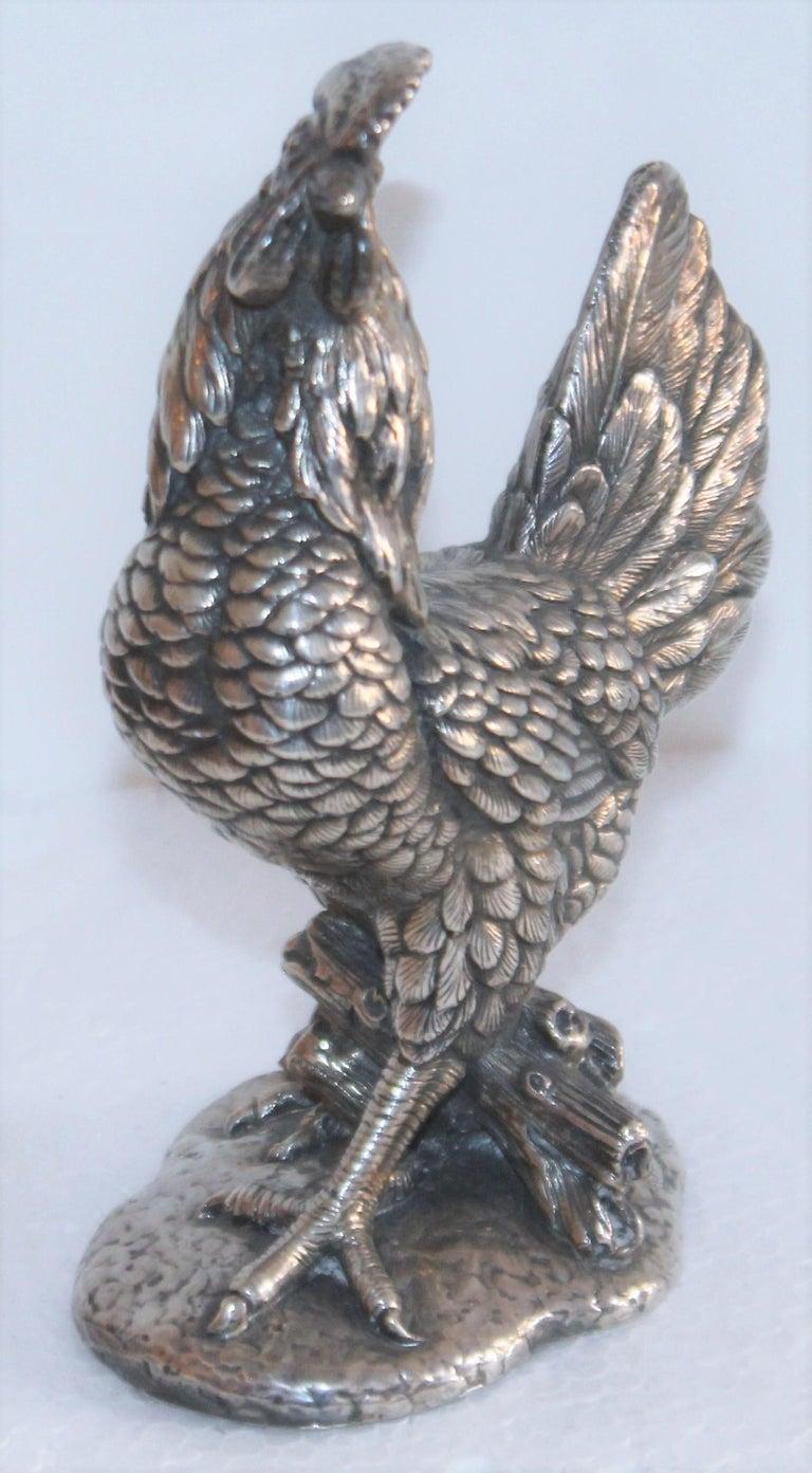 This sterling silver heavy hollow body rooster figure is signed 925 on the base and is in fine condition.
Beautifully made and proportioned well. Great patina.