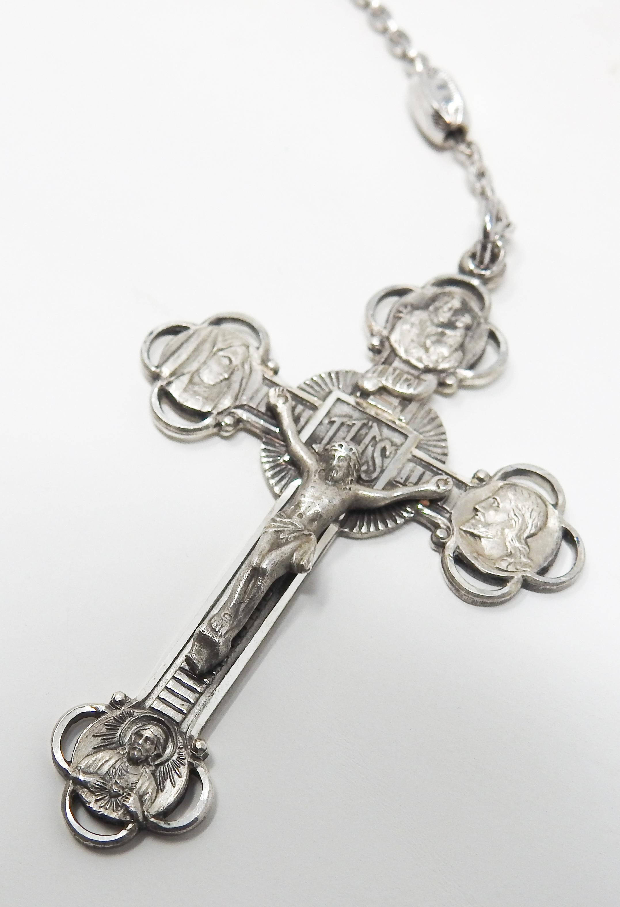 Offering this immaculate sterling silver rosary by AFCO Sterling. The strand is sterling silver beads, and each of them have a cross and heart engraved on them. The heart that brings the chain together is marked sterling and has four engravings with