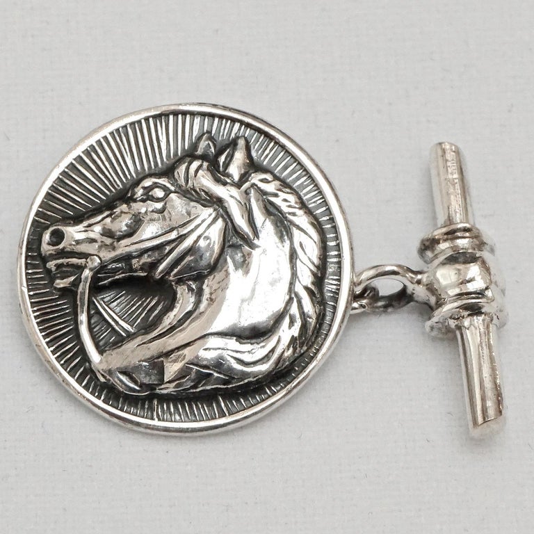 Sterling silver round cufflinks featuring a wonderful textured and shiny horse head design. Measuring diameter 2cm / .78 inch. They have scratching, as expected. We have given the cufflinks a light clean.

This is a stylish pair of quality silver