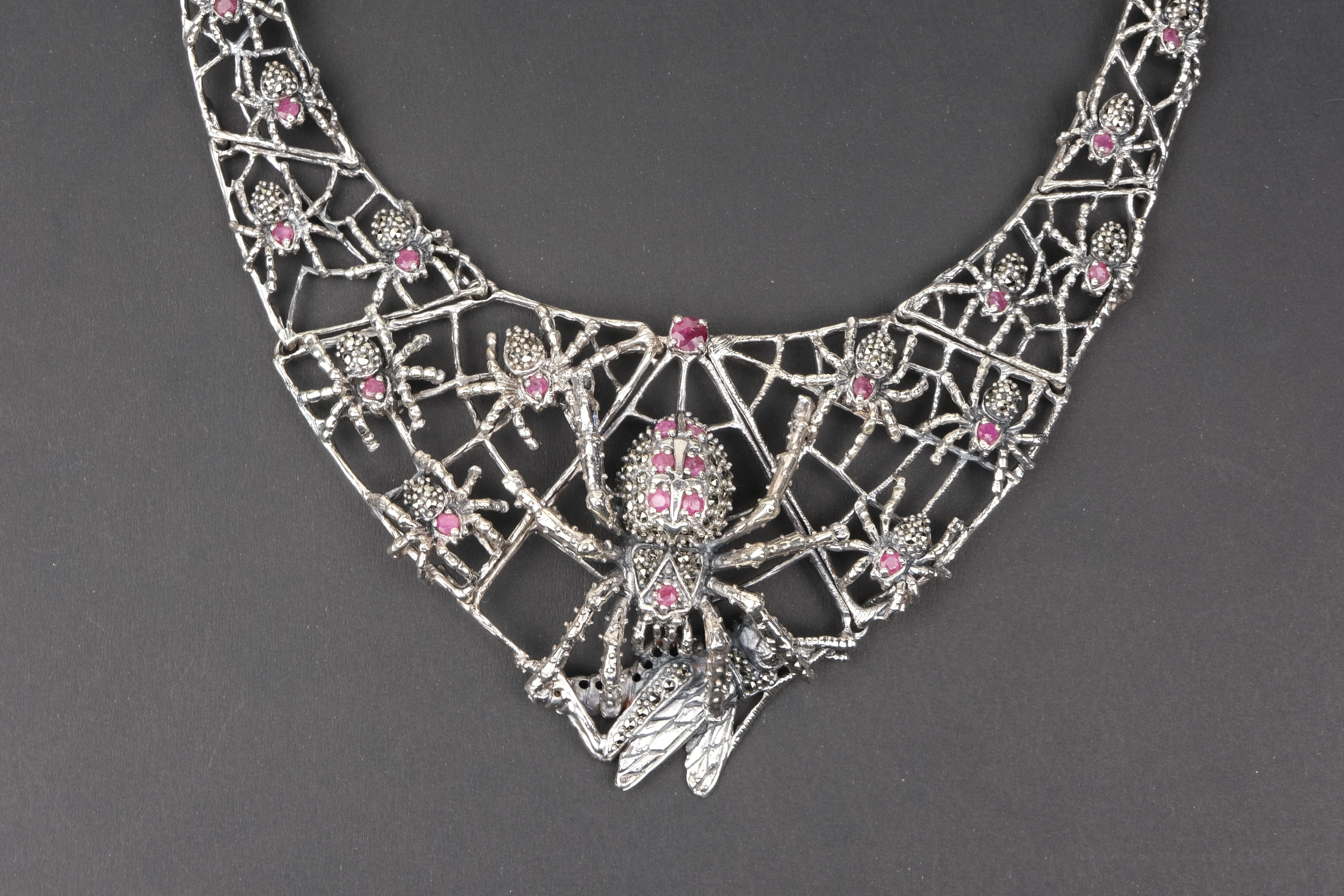 Sterling Silver Ruby and Marcasite Spider and Web Bib Necklace

I have never really understood arachnophobia, people’s fear of spiders. I know that walking face first into a spider’s web in a dark basement can be a little disconcerting but I think