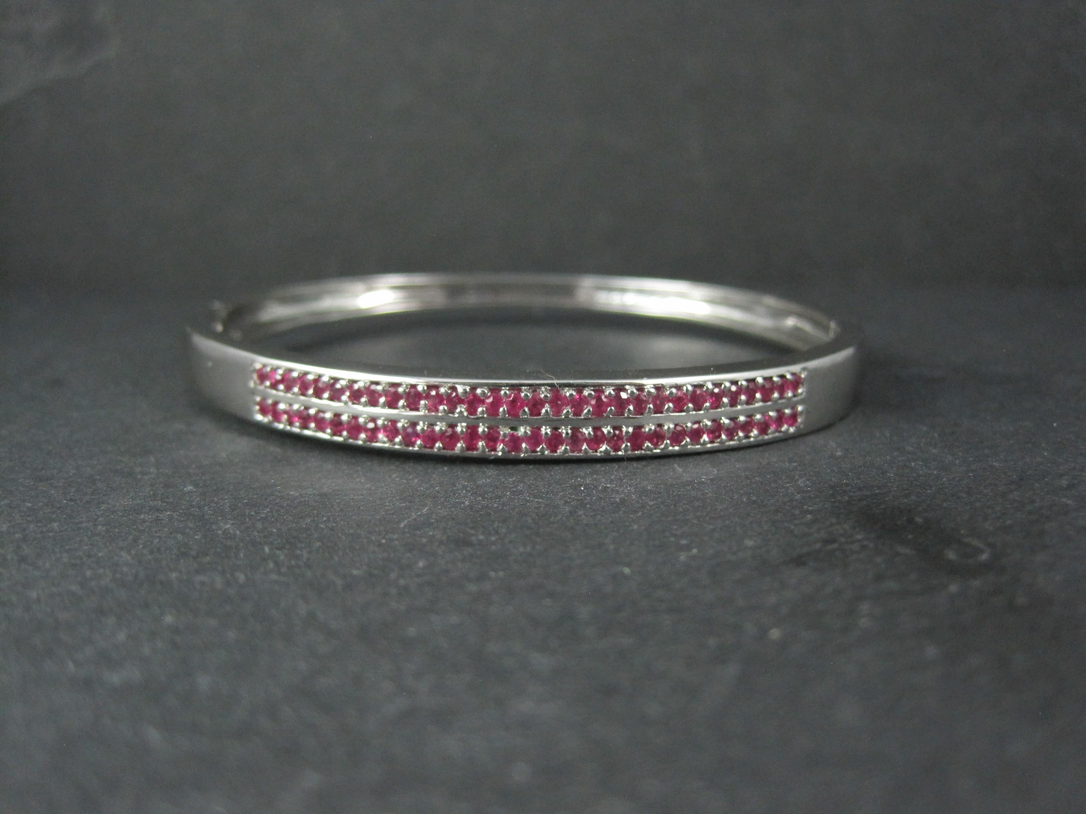 This gorgeous bangle bracelet is sterling silver.
It features 62 genuine round cut, 1mm rubies.

The face of this bracelet measures 1/4 of an inch wide.
It has an inner diameter of 2 1/4 by 2 1/2 inches and an inner circumference of 7 1/4