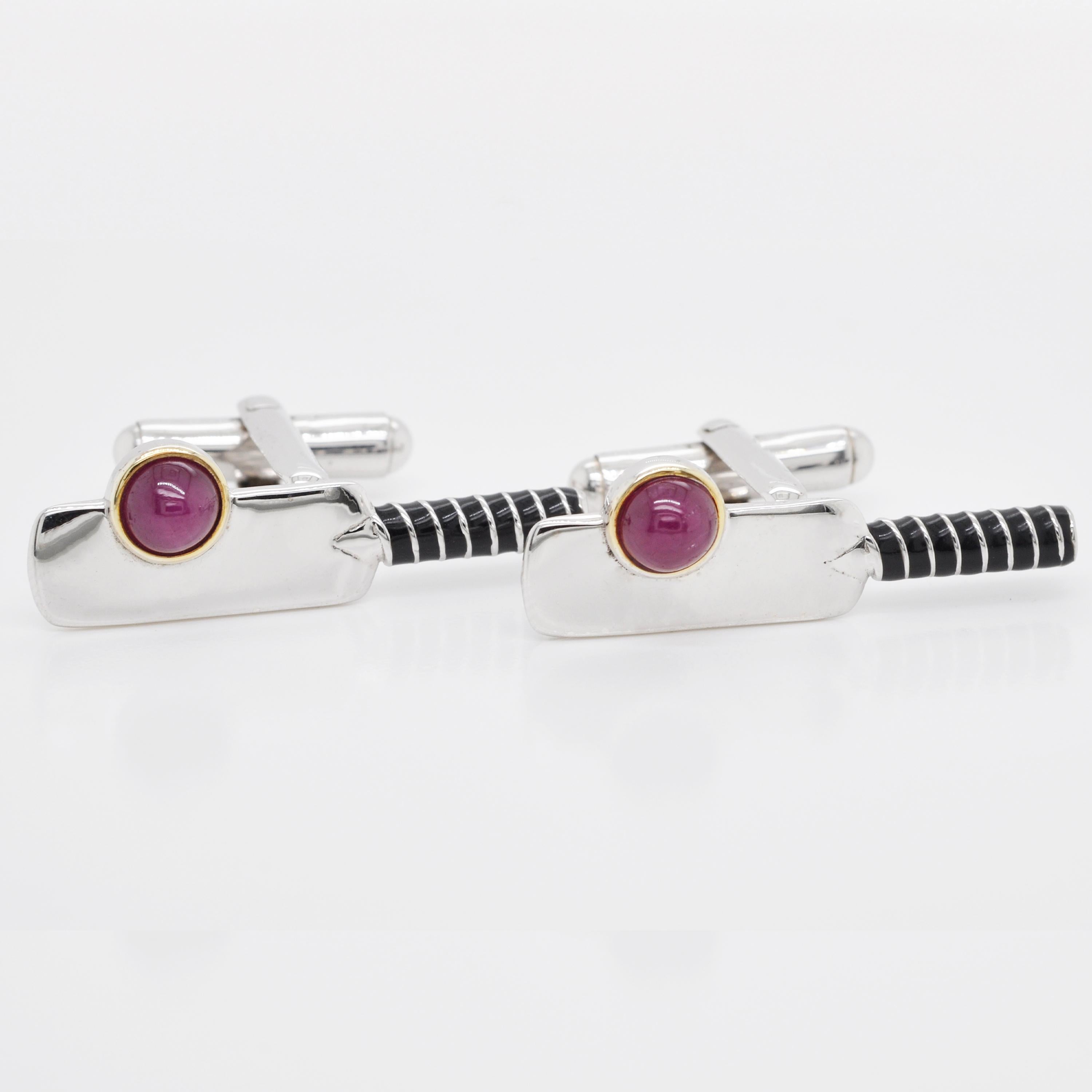 Eye catching ruby cabochon cricket ball and bat enamel cufflinks made in sterling silver. 

These cufflinks are a tribute to the Cricket Lovers all around the globe. Capturing the spirit of the game, the sterling silver cufflinks features a well