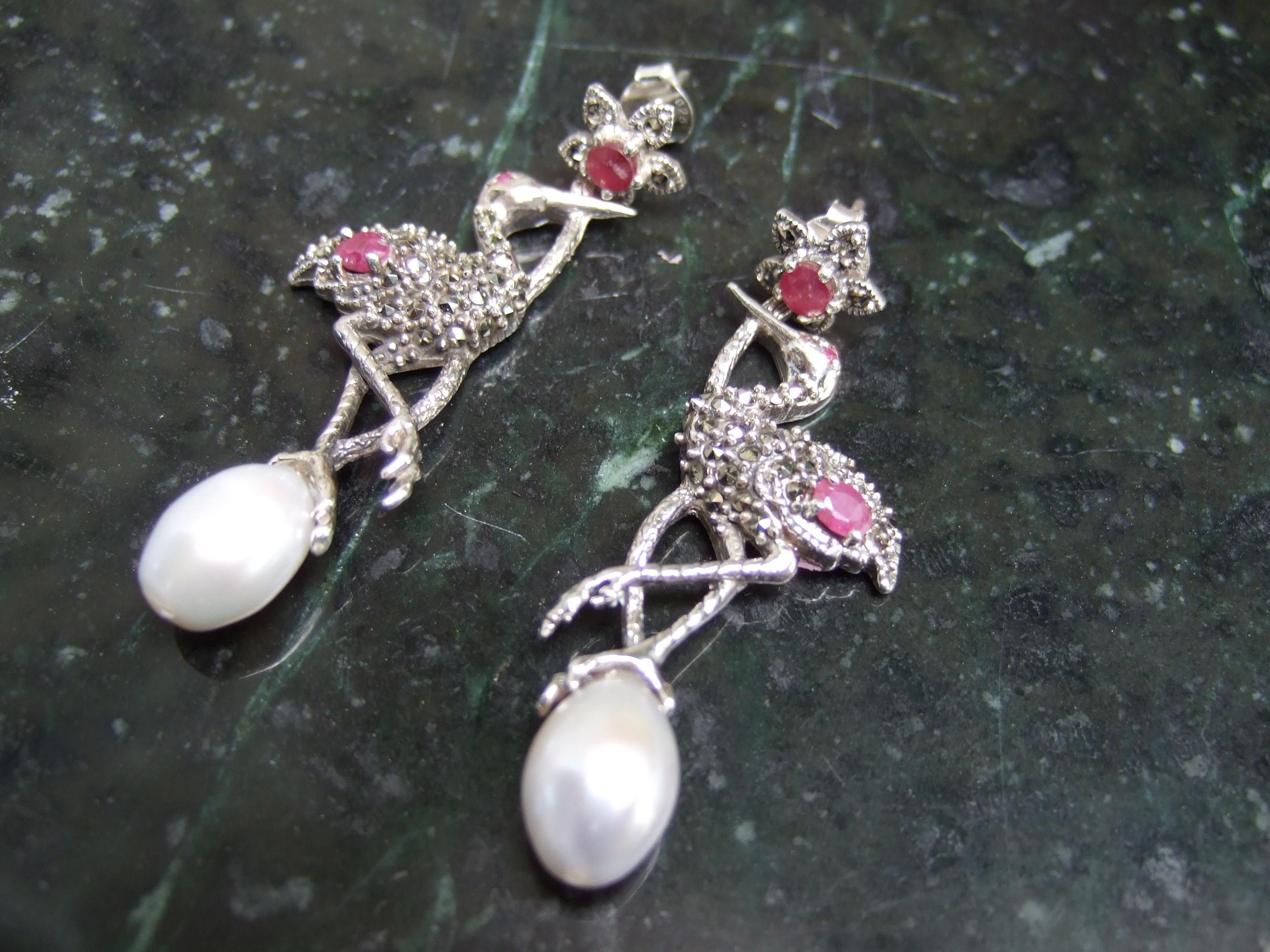 Exquisite sterling silver ruby crystal fresh water pearl marcasite bird earrings 21st c 
The elegant sterling silver earrings encrusted with ruby color prong set crystals
Accented with clusters of glittering marcasites

Each of the birds is