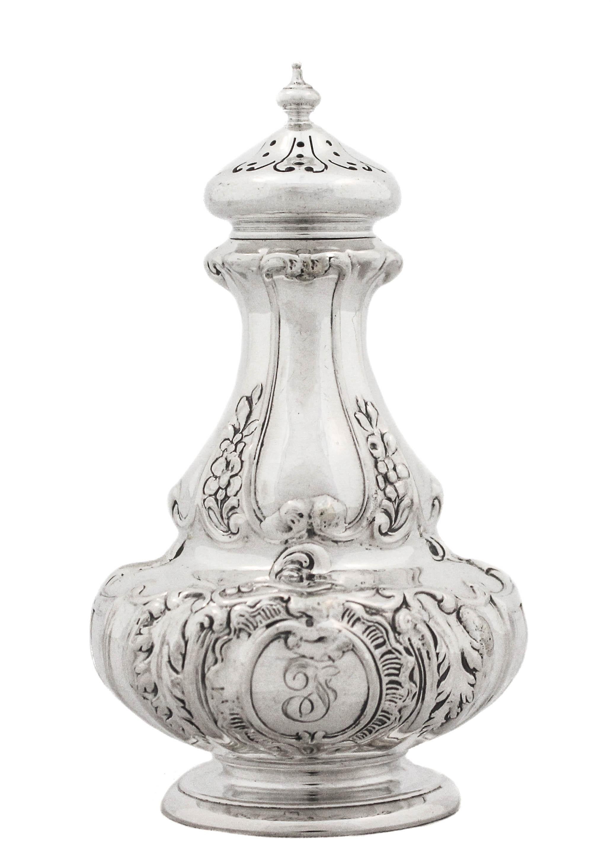 We are delighted to offer you these sterling silver salt shakers by Gorham Silversmiths, hallmarked 1900.  They have an old-world regalia that reflects the Gilded Age of the 19th century.  Ornate with a floral motif and a reticulated top, they stand
