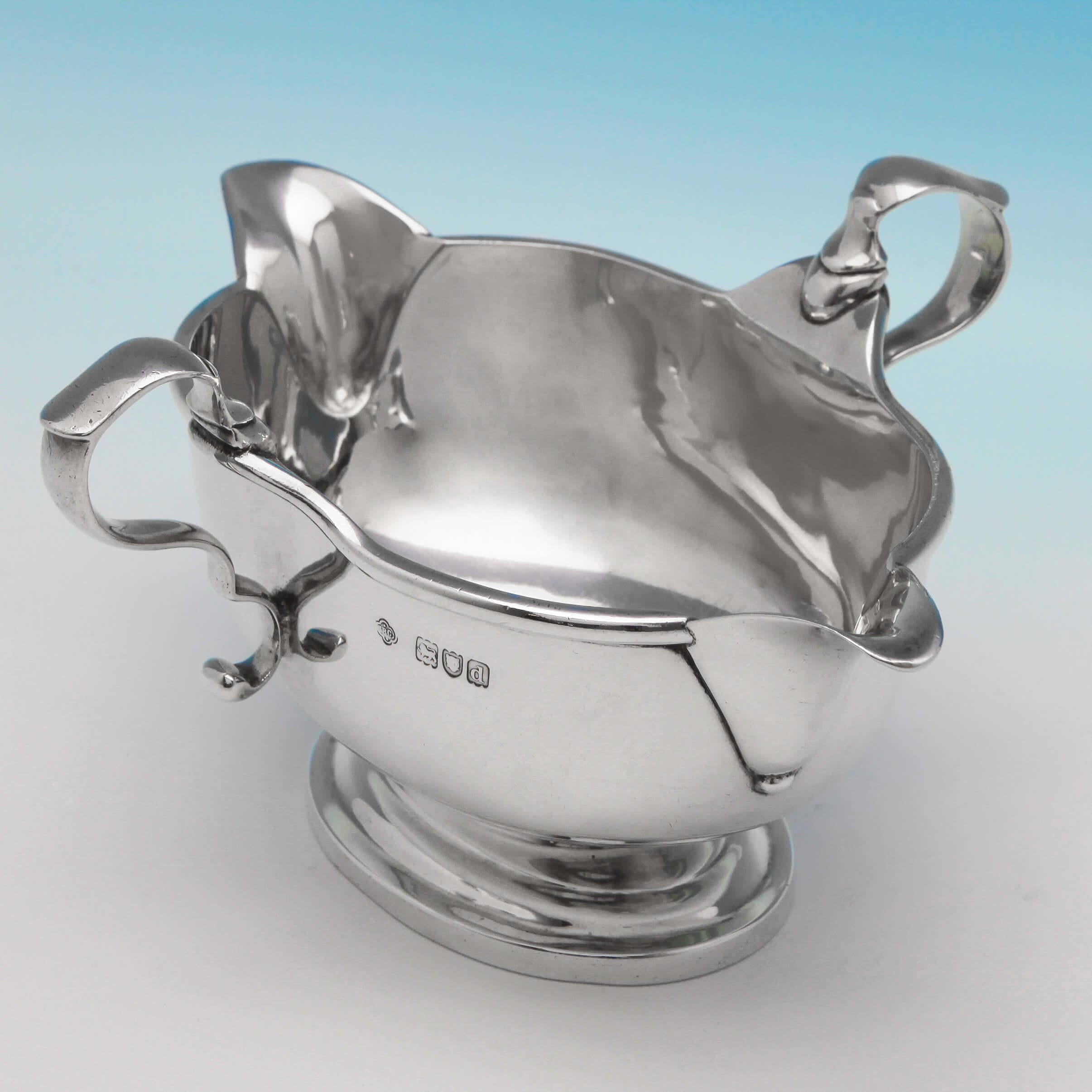 Hallmarked in London in 1899 by Carrington & Co., this handsome, Victorian, Antique Sterling Silver Sauce Boat, is plain in style, and double sided, replicating the original style of English silver sauce boats first seen during the 1690's. The sauce
