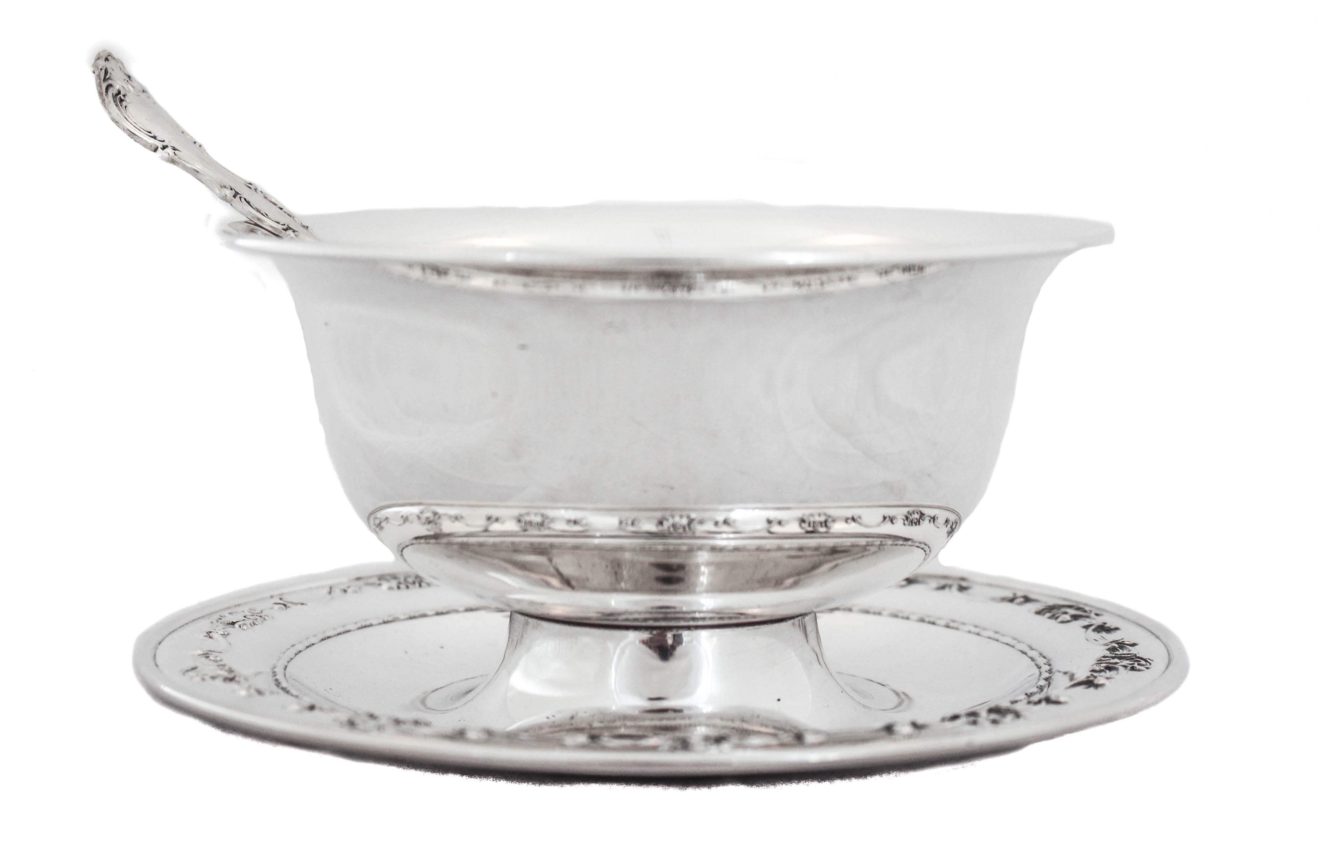 Being offered is a sterling silver sauce-bowl and spoon in the Strasbourg pattern by Gorham Silversmiths.  The Strasbourg pattern is known for its scalloped design as seen around the rim of the plate and on the serving spoon.  The bowl of the spoon
