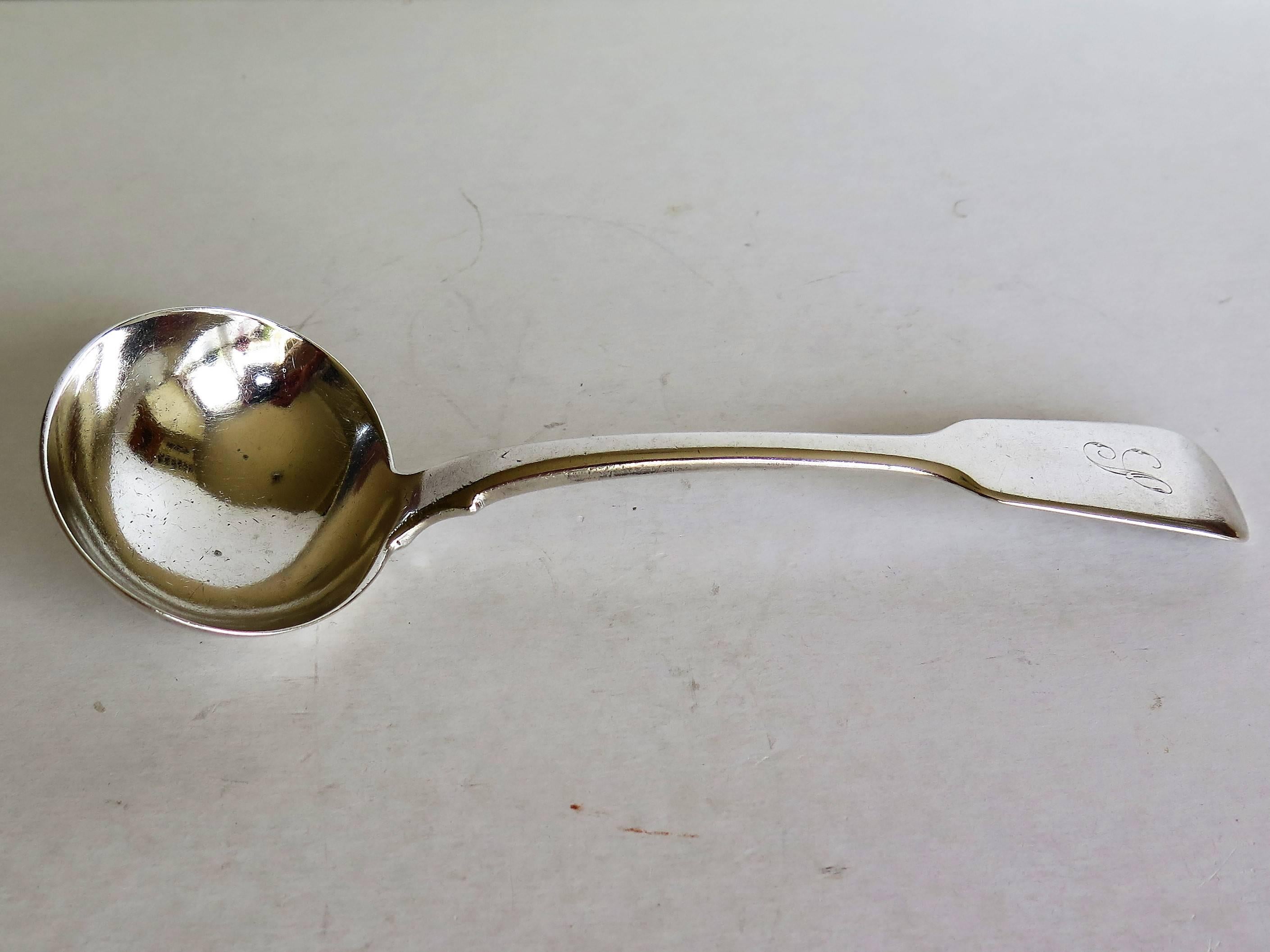 This is a good, heavy, fiddle-back, sterling silver sauce ladle or spoon, made by Charles Boyton of London and dating to very early in Queen Victoria's reign, 1838. 

The ladle has the classic Fiddle back pattern shape which was first made in