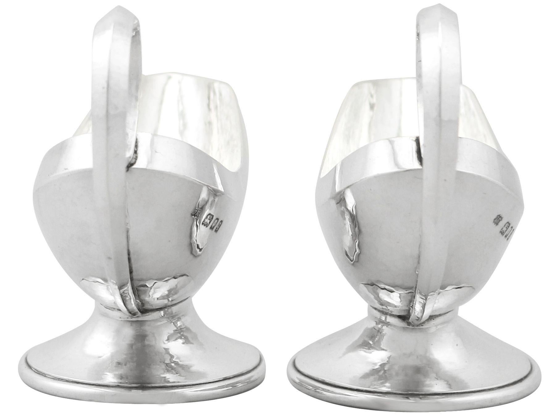 An exceptional, fine and impressive pair of antique George V sterling silver sauceboats made in the Design style by Omar Ramsden; an addition to our dining silverware collection.

These exceptional antique George V sterling silver sauceboats have