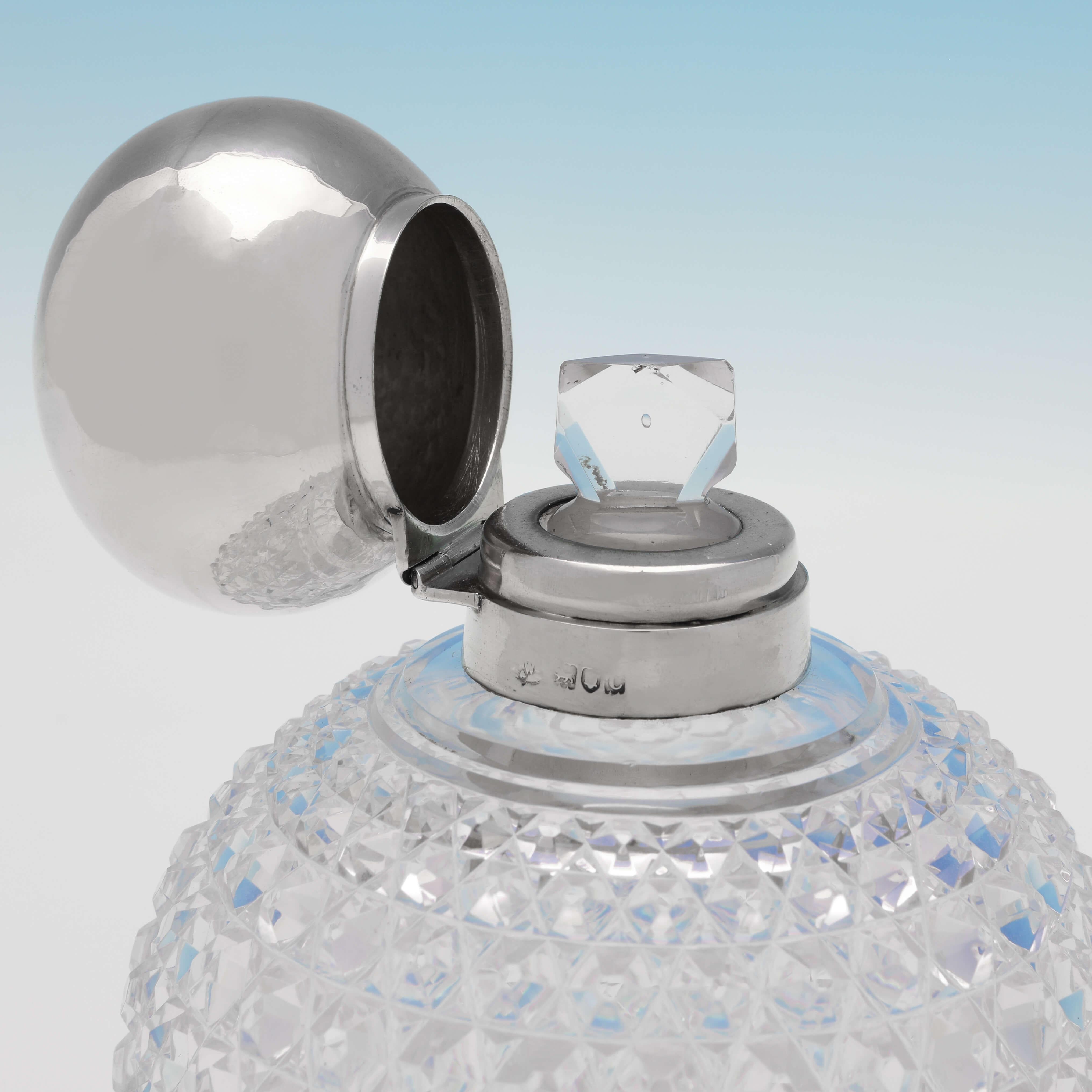 Hallmarked in London in 1898 by Mappin & Webb, this handsome, Victorian, antique sterling silver scent bottle, features a cut glass body, and a plain silver mount and lid. The scent bottle measures 6.25