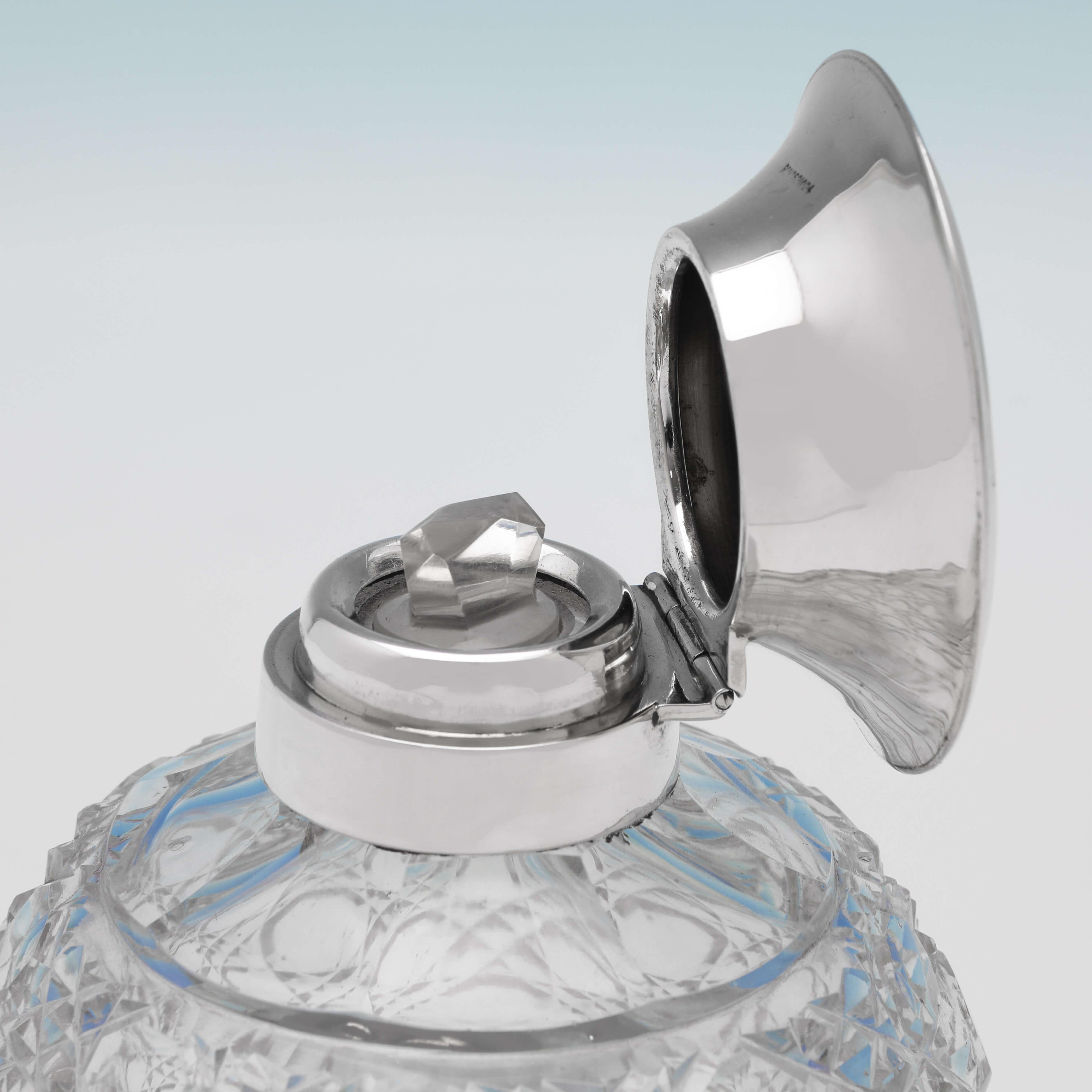Hallmarked in Sheffield in 1913 by James Dixon & Sons, this George V, antique sterling silver scent bottle, features a hobnail cut glass body, and an engraved silver lid. The scent bottles measures 4.5