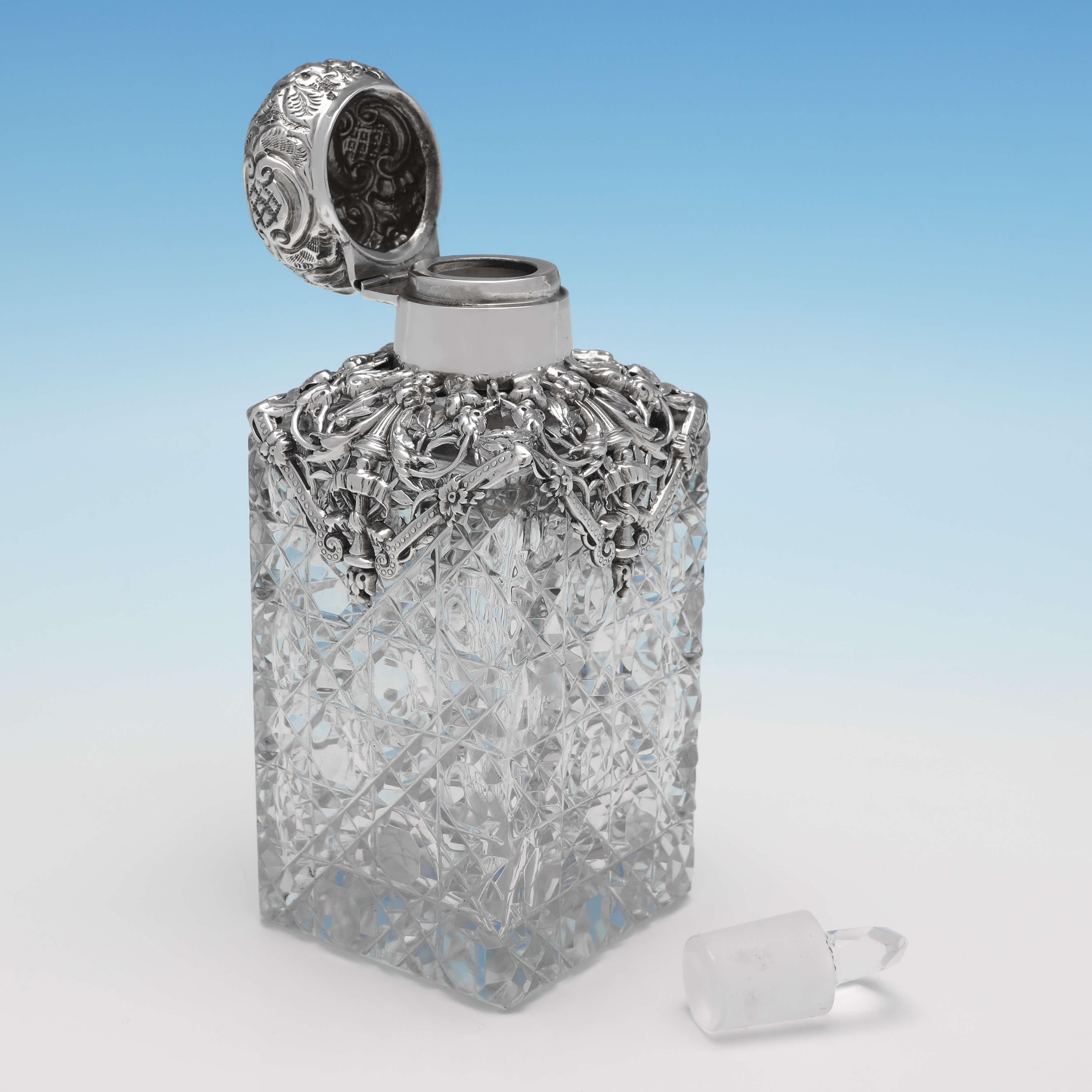 Hallmarked in London in 1896 by R. Halford & Sons, this very attractive, Victorian, Antique Glass & Sterling Silver Scent Bottle, feature a hobnail cut glass body, and an ornate silver mount. The scent bottle measures 5.5