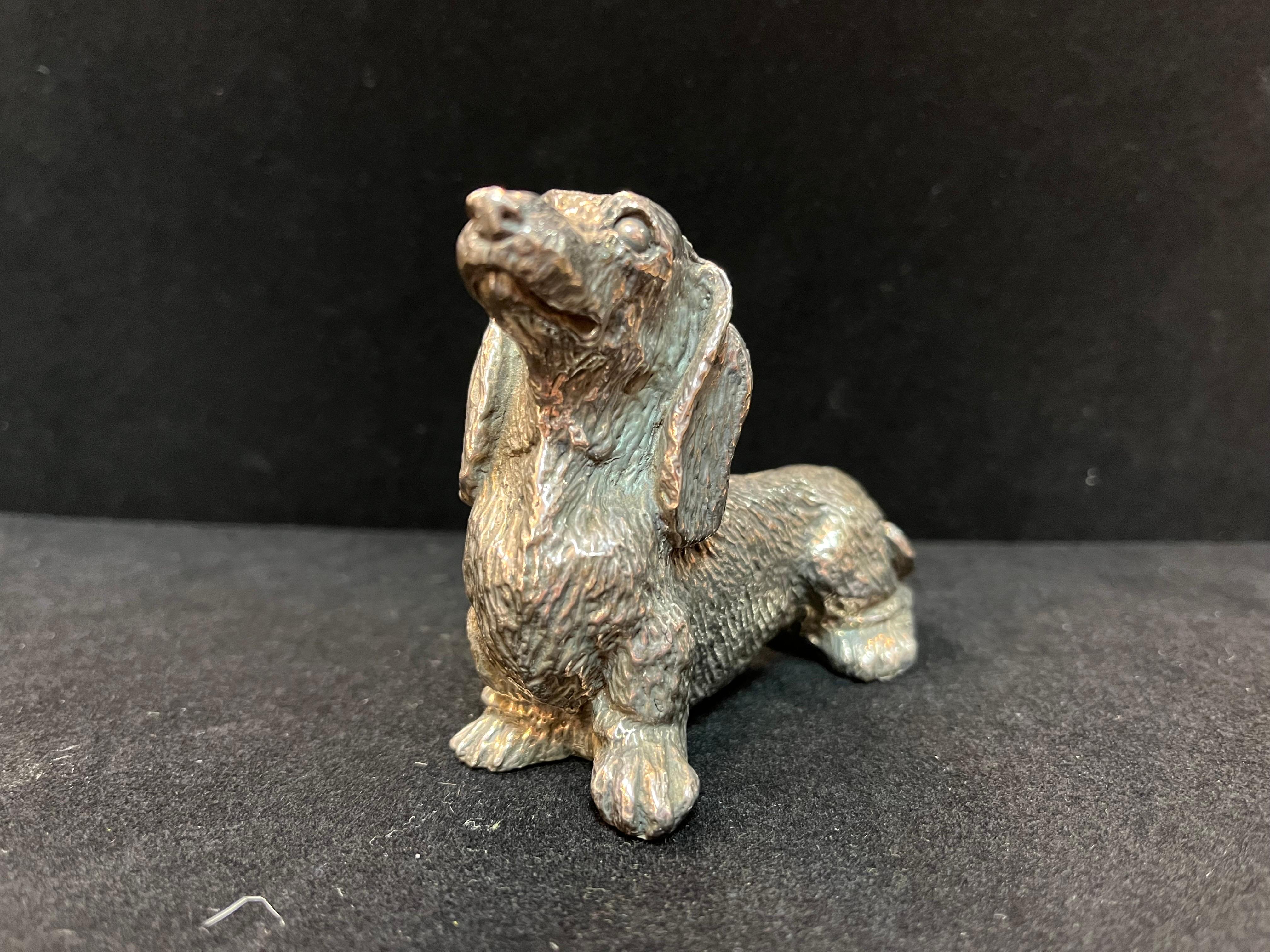 An adorable long haired dachshund dog in sterling silver. This little sterling silver sculpture depicts the dachshund in 360 degrees. And who doesn't love a dachshund? The AKC website describes, 