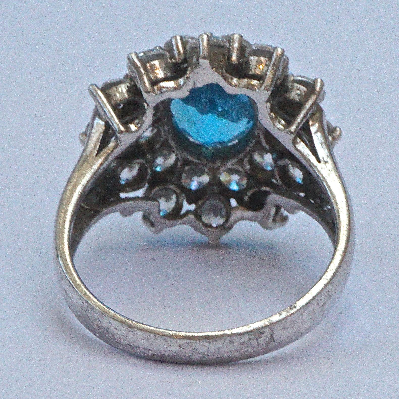 Beautiful sterling silver ring featuring an oval sea blue centre rhinestone, surrounded by  two rows of clear rhinestones. Ring size UK O 1/2 , US 7 1/4, inside diameter 1.8cm / .7 inch. The front measures 2cm / .78 inch by 1.9cm /  .74 inch.

This
