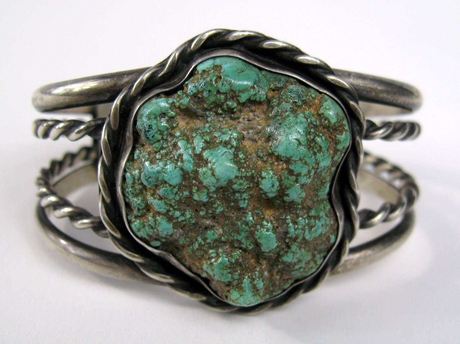 Lovely Old Pawn hand crafted Navajo Sterling bracelet. 4 Rings, 2 solid and 2 are twisted silver. Large sea foam turquoise stone measuring  approx. 1.20 inches x 1.40 inches. The bracelet measures 1.60inches at the widest and graduates down to .60