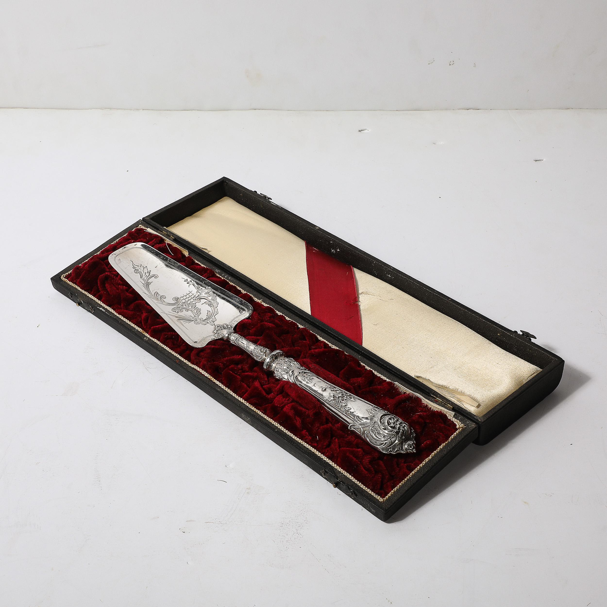 Este exquisito servidor de plata de ley, fabricado hacia 1880, es un buen ejemplo de la excepcional mano de obra de los plateros belgas Delheid Fréres. El servidor está adornado con detalles ornamentales cincelados, que muestran intrincados diseños