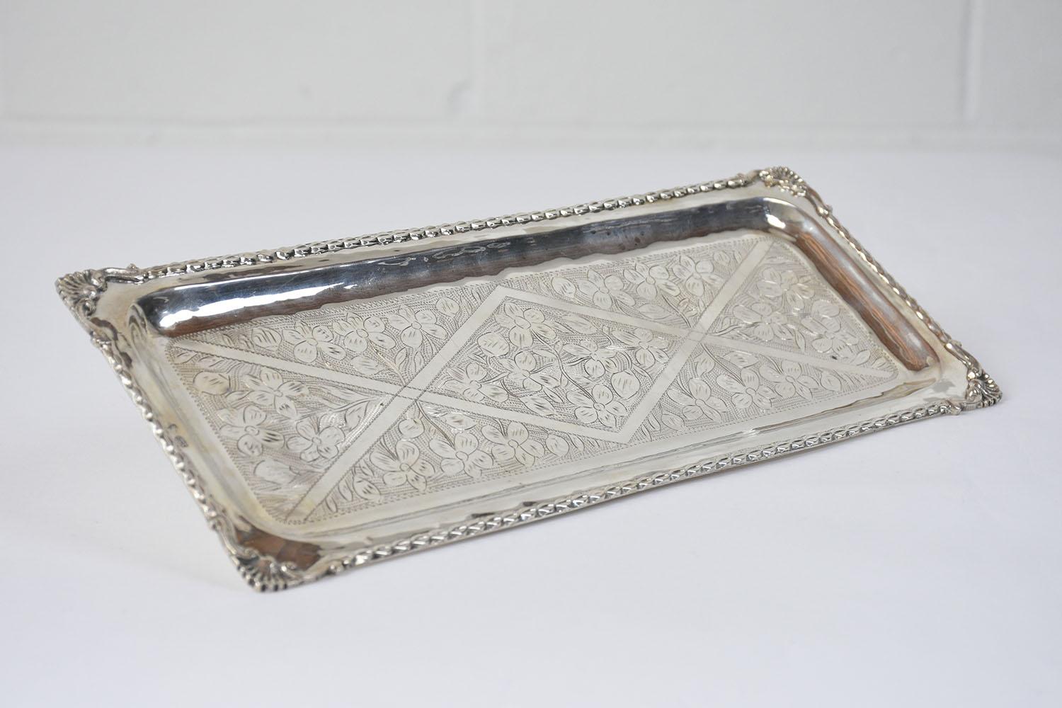 Unveil the beauty and elegance of our French 1970s Silver Platter, a testament to skilled craftsmanship and timeless design. This extraordinary platter, handcrafted with precision, is in impeccable condition and is a testament to the quality of