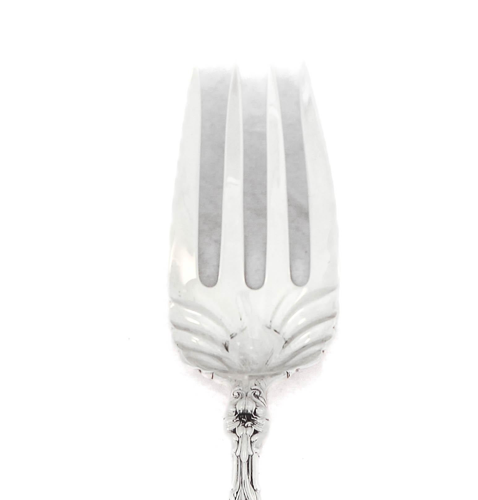 Being offered is a sterling silver serving fork in the “Lily” pattern by Whiting Manufacturers.  First introduced in 1910 at the height of the Art Nouveau period, “Lily” is quintessential Art Nouveau!  With its floral motif and fluid shape it draws