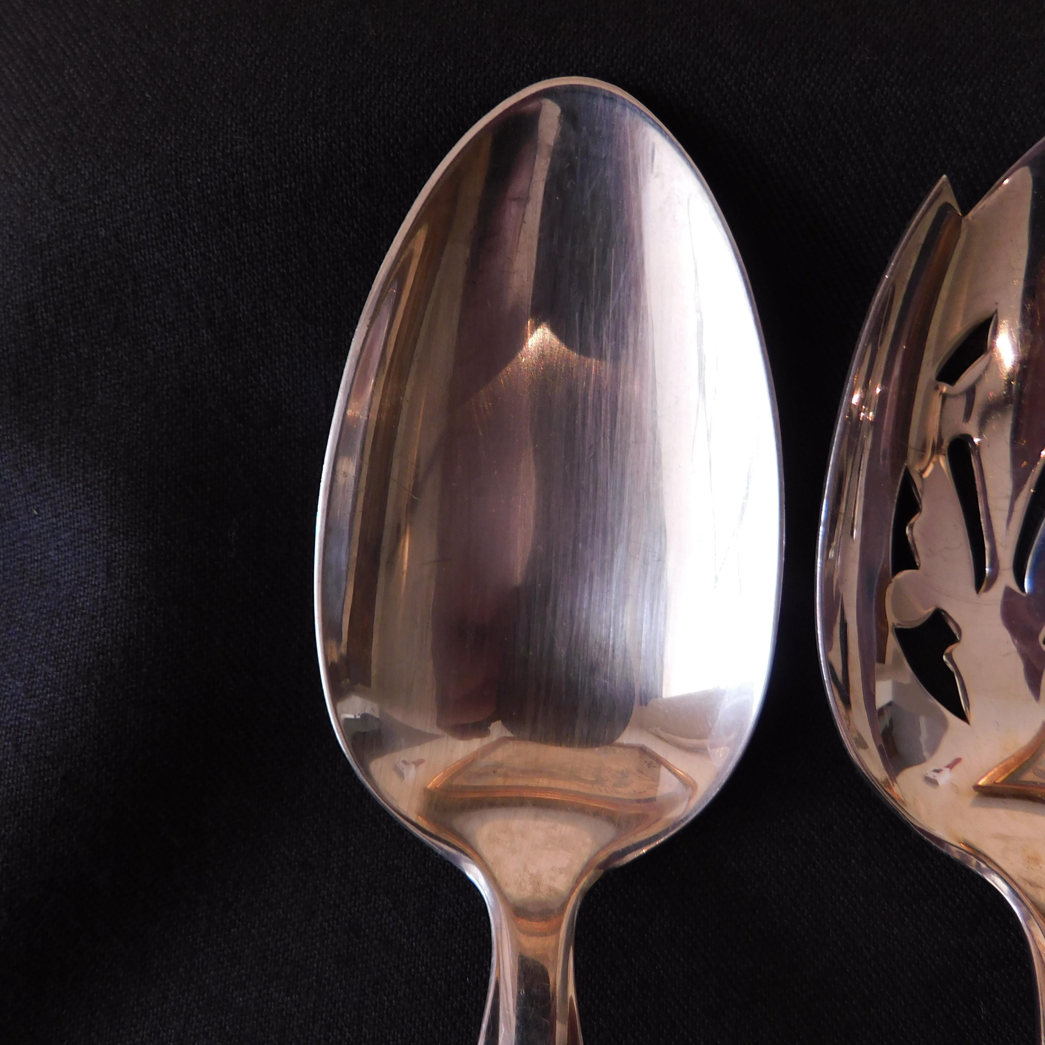  1810 pattern Sterling silver serving spoons by International Sterling . The set includes a serving spoon, a pierced serving spoon and a sugar spoon. Marked 