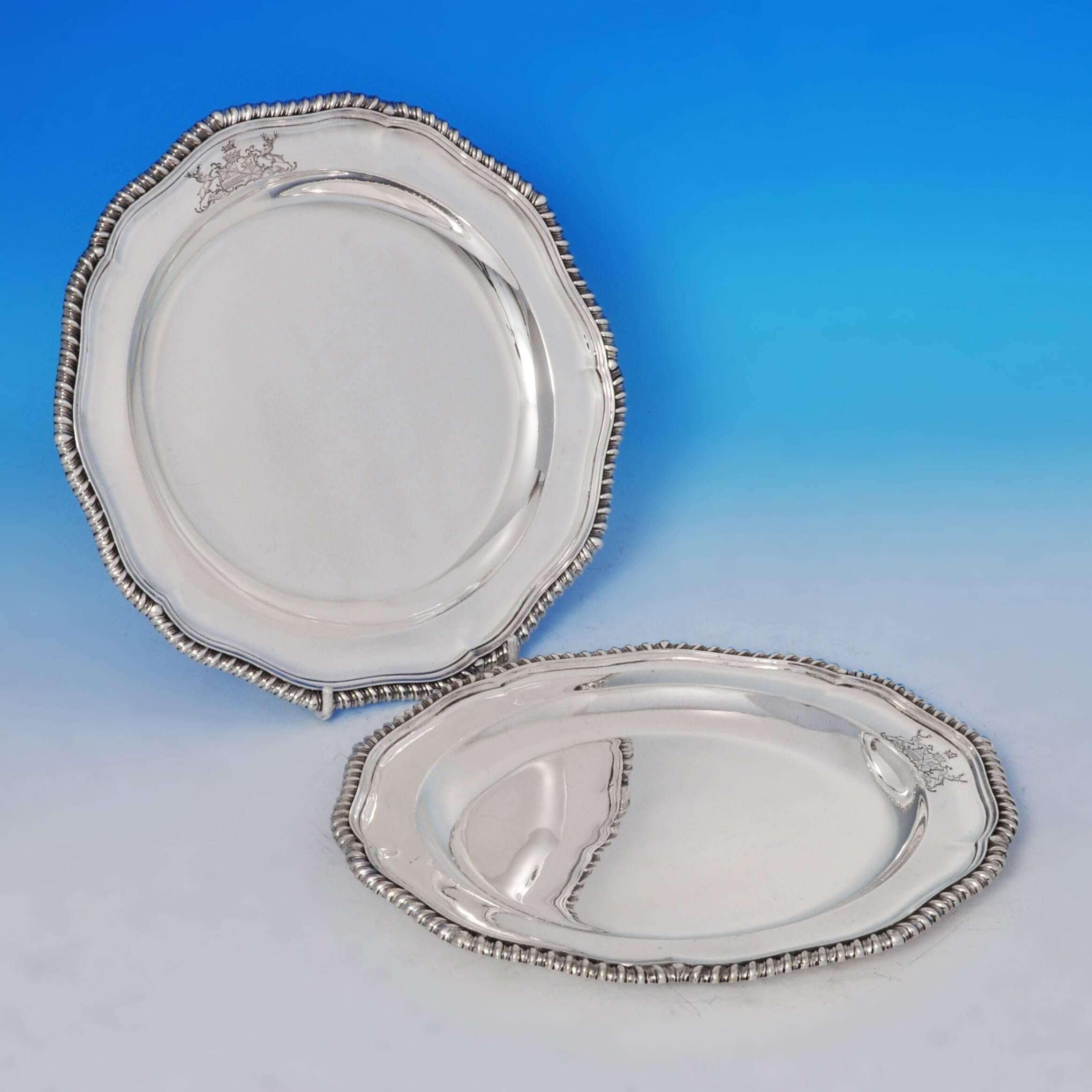 Hallmarked in London, in 1800 by Timothy Renou, this handsome, George III, Antique, sterling silver set of 12 plates, feature shaped gadroon borders and engraved coat of arms. Each plate measures 10 inches (25.5cm) in diameter, and the set together