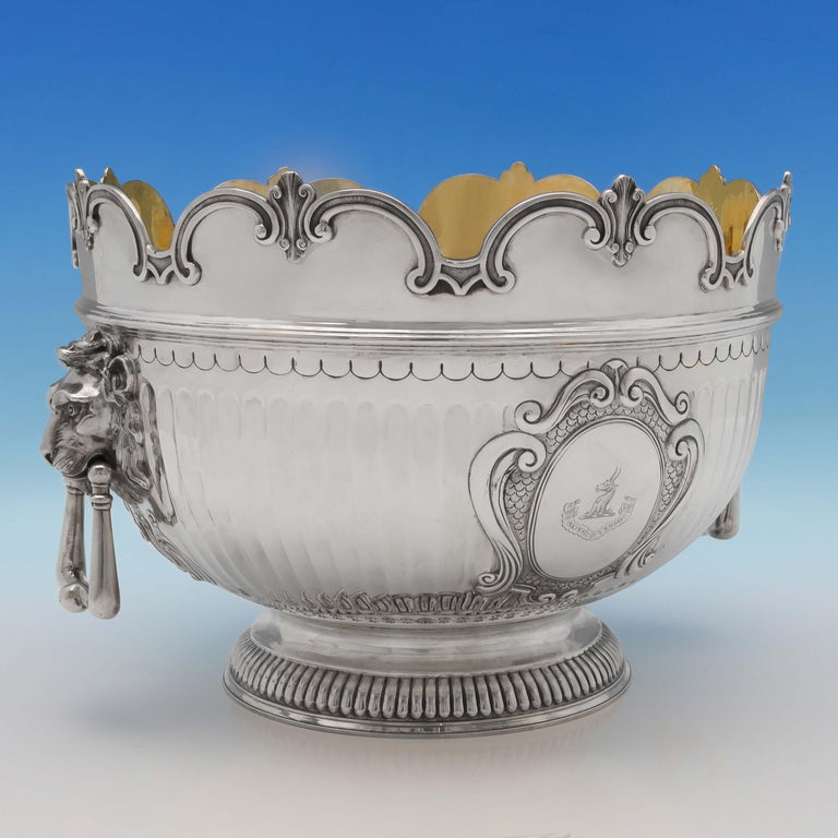 Hallmarked in London in 1889 and 1893 by Barnards, this fantastic, set of 3 Antique Sterling Silver Bowls, are in the ‘Monteith' style, featuring gilt interiors, engraved crests and mottos, and lion mask drop rings handles. The larger central bowl