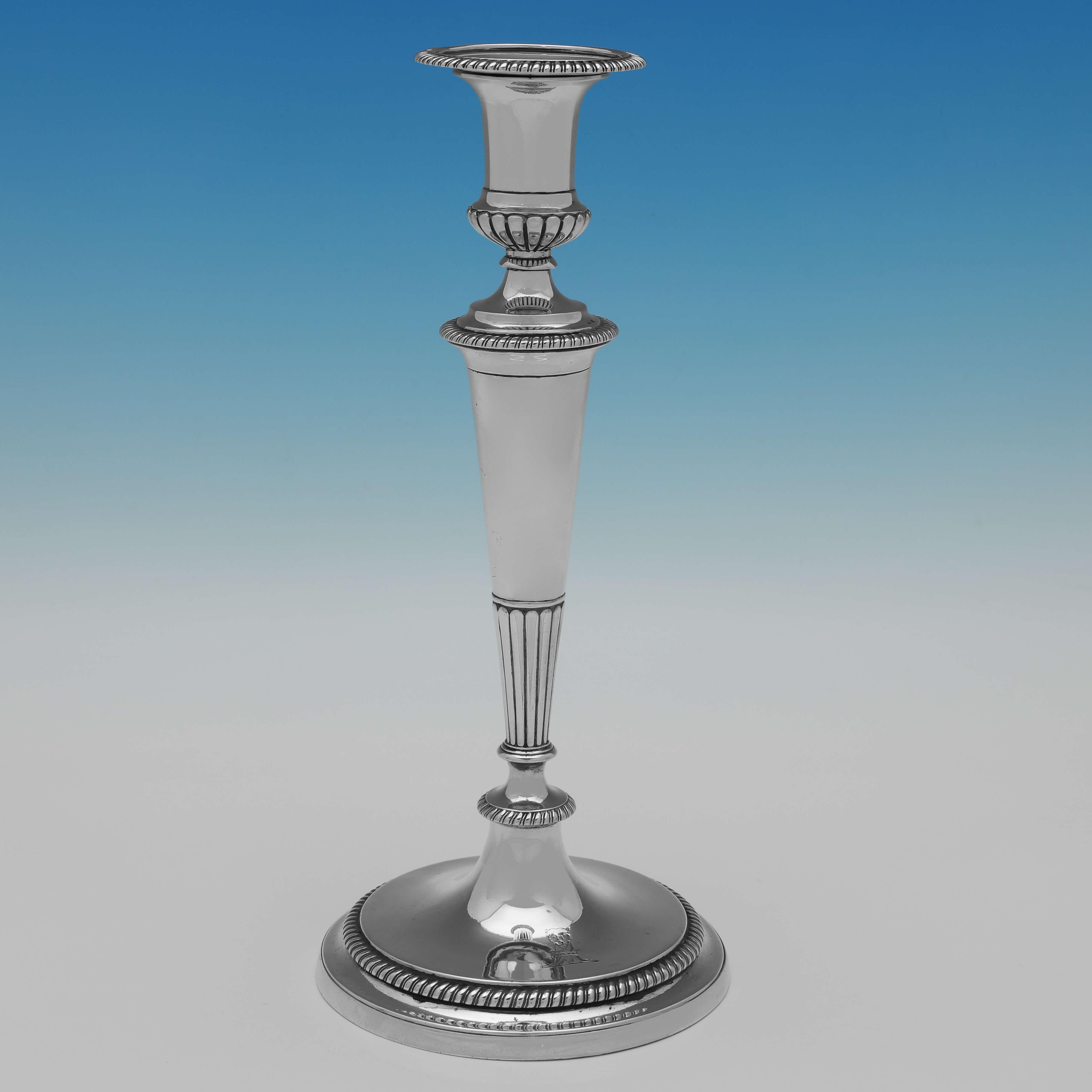 Hallmarked in London in 1798 by the master candlestick maker John Scofield, this important set of four Neoclassical, Antique Sterling Silver Candlesticks, show the refined elegance Scofield was famous for. 
Unlike most candlesticks of this period