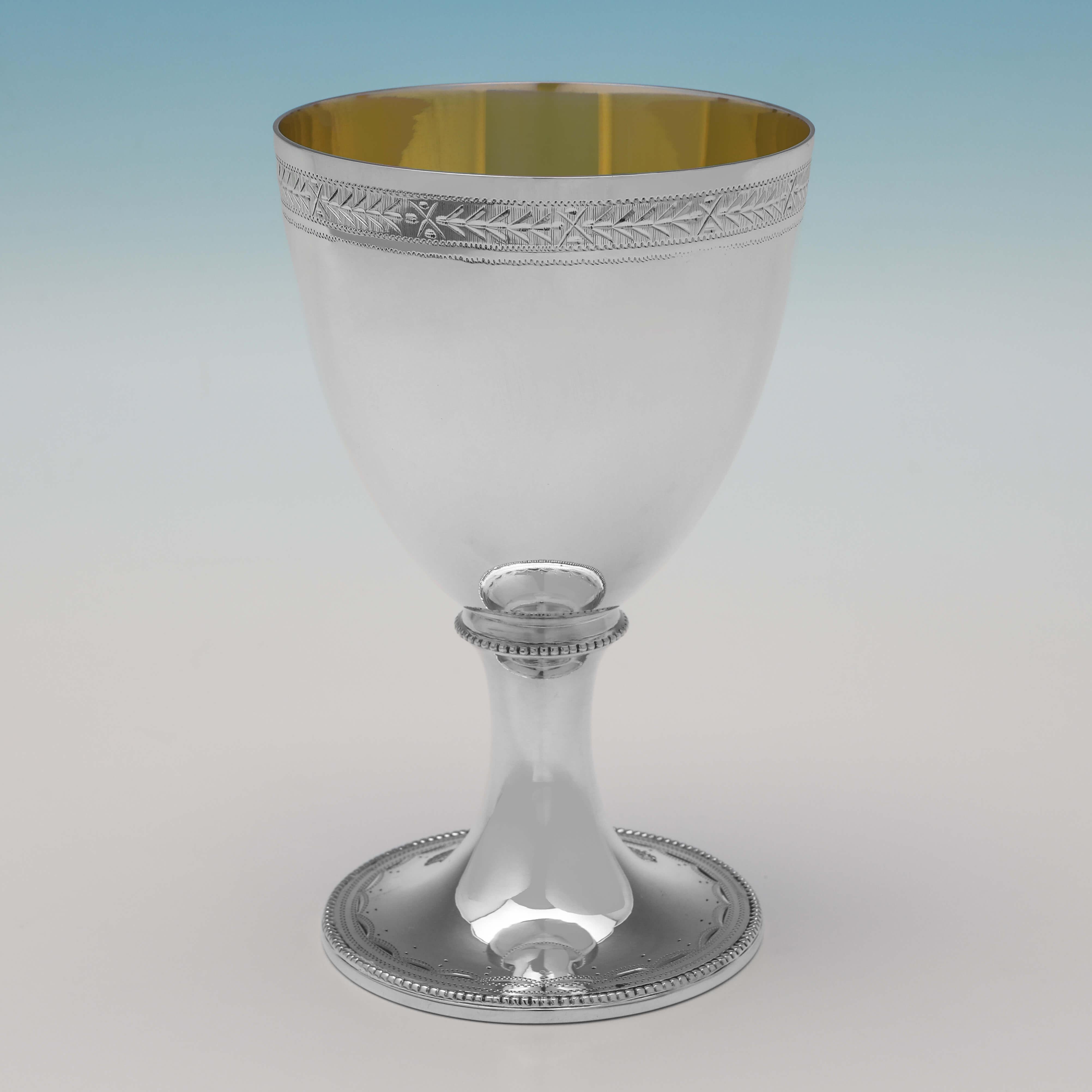Hallmarked in London in 2000 by C. J. Vander, this handsome set of 6 Sterling Silver Goblets, feature bright cut engraved decoration and gilt interiors. Each goblet measures 5.75