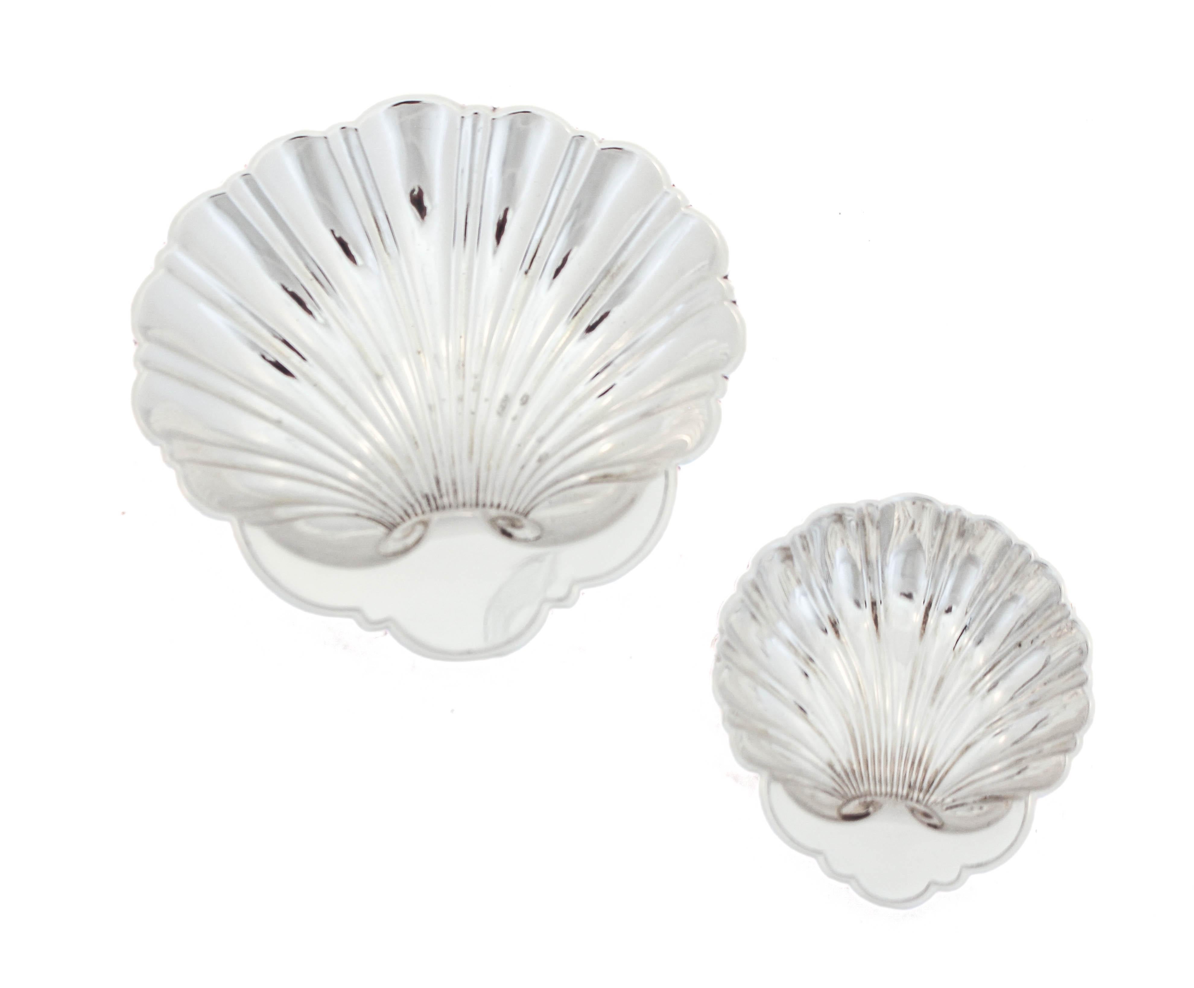 Being offered is a suite of shell dishes by William Durgin Silver.  There are seven dishes in total one large and six smaller.  The large one has three balls on the bottom, lifting it off the surface. A lovely suite of dishes to use when