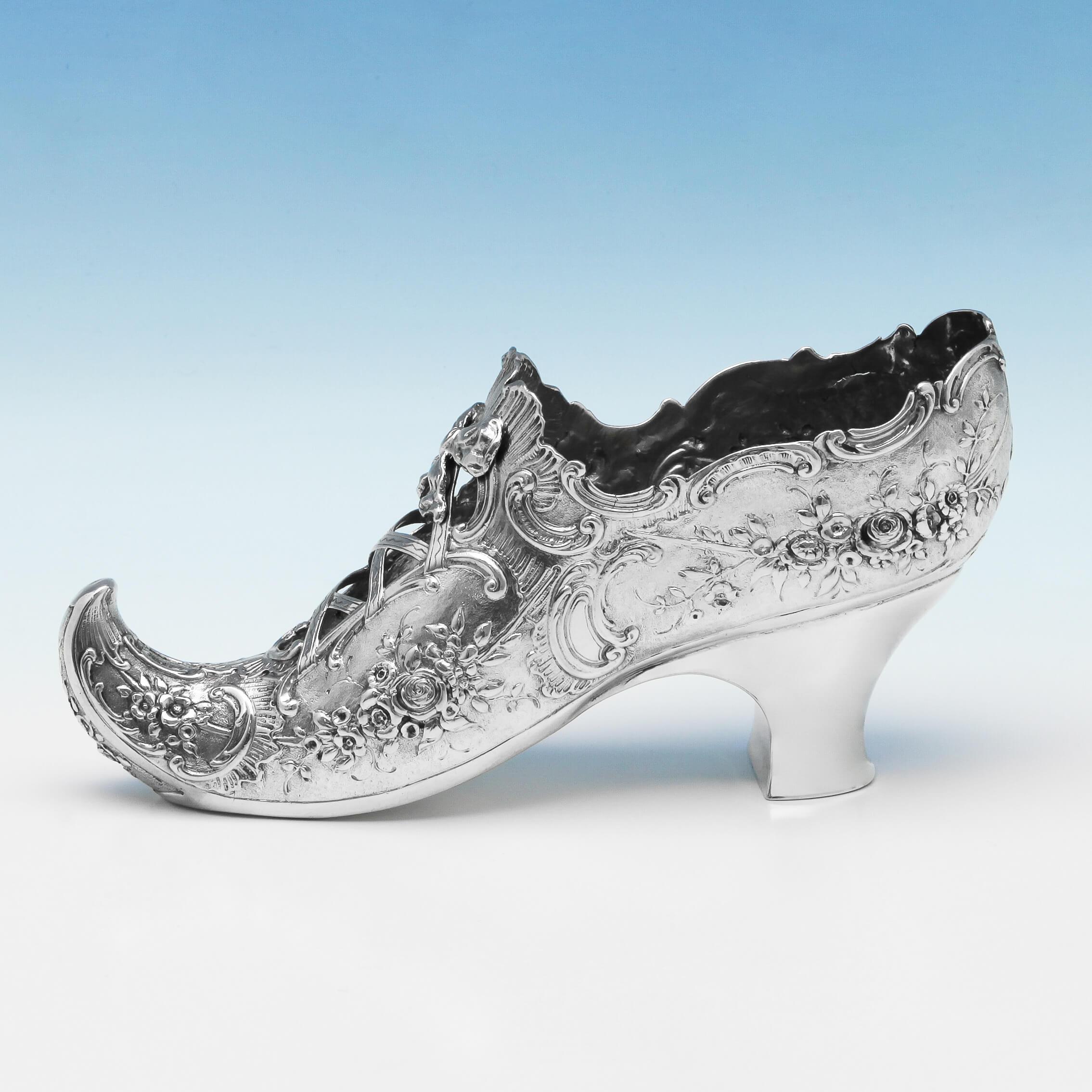 Carrying import marks for London in 1896 by Edwin Thompson Bryant, this Antique Sterling Silver Model of a Shoe, features attractive chased decoration. The shoe model measures 3.75