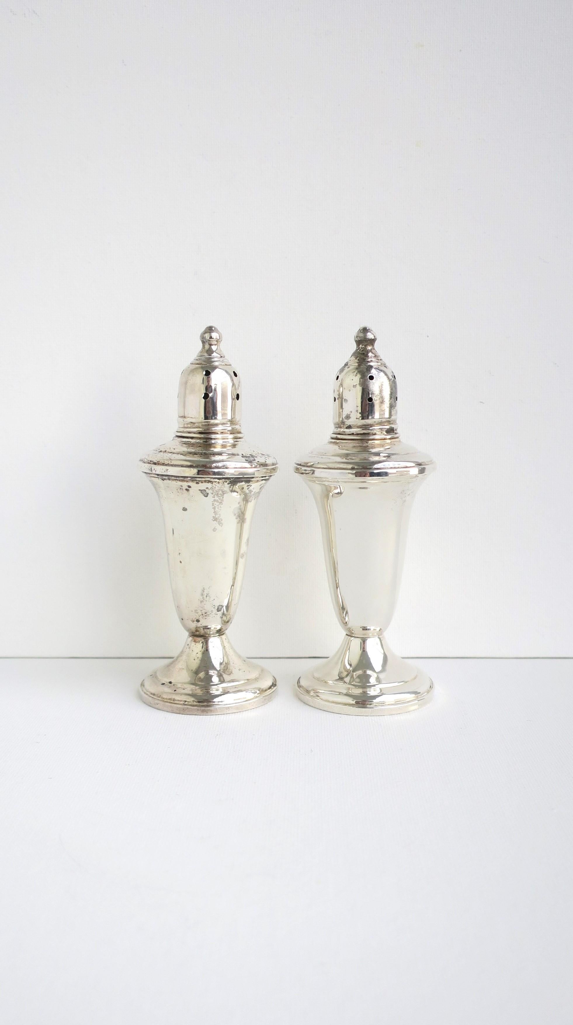 A pair of sterling silver salt and pepper shakers by Shreve Crump & Low, circa 20th century, USA. A great set for everyday use or special occasions. Dimensions: 4.75